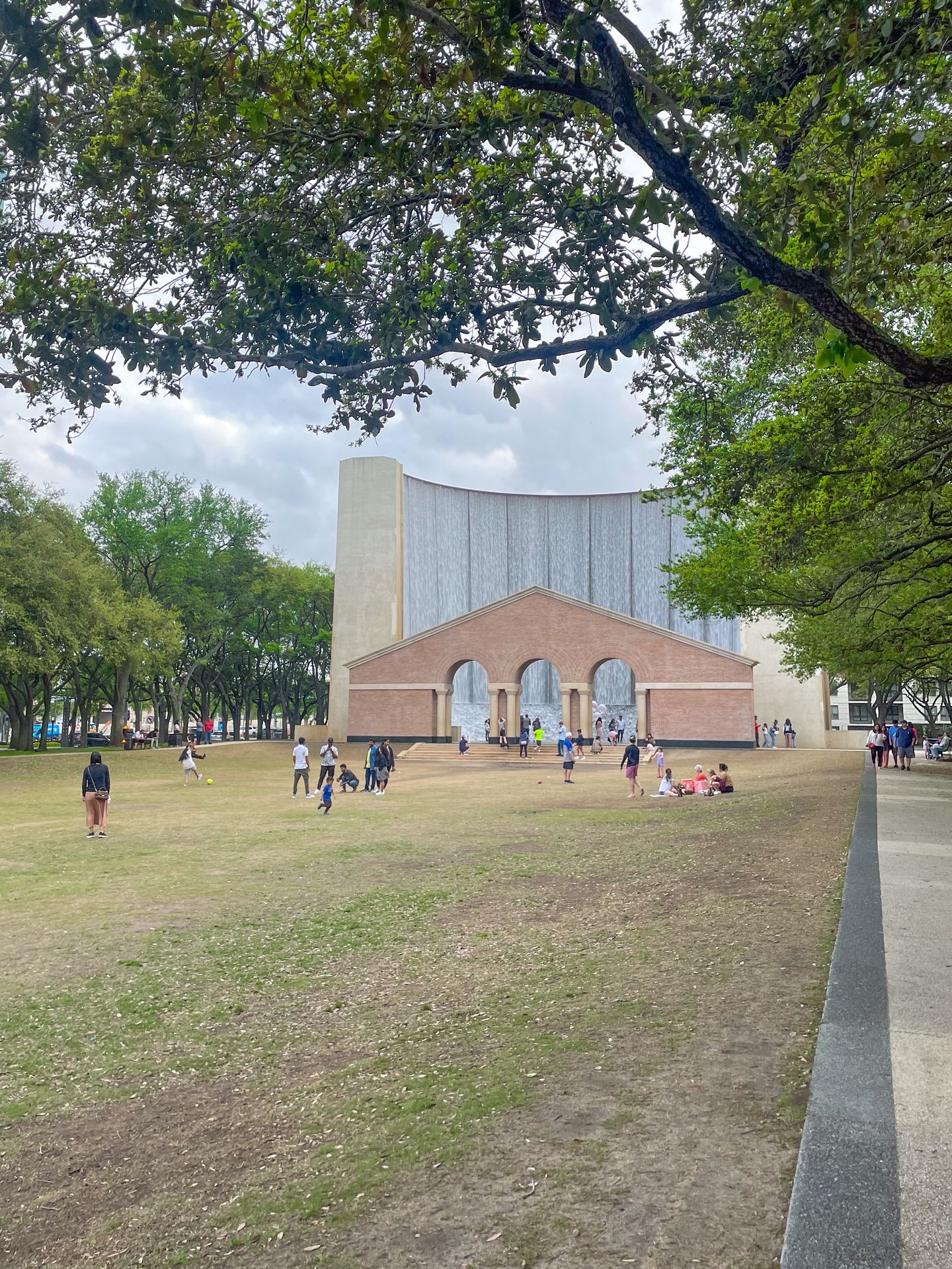 Looking down the lawn of the park and at the Waterfall fountain in Gerald D. Hines Waterwall Park