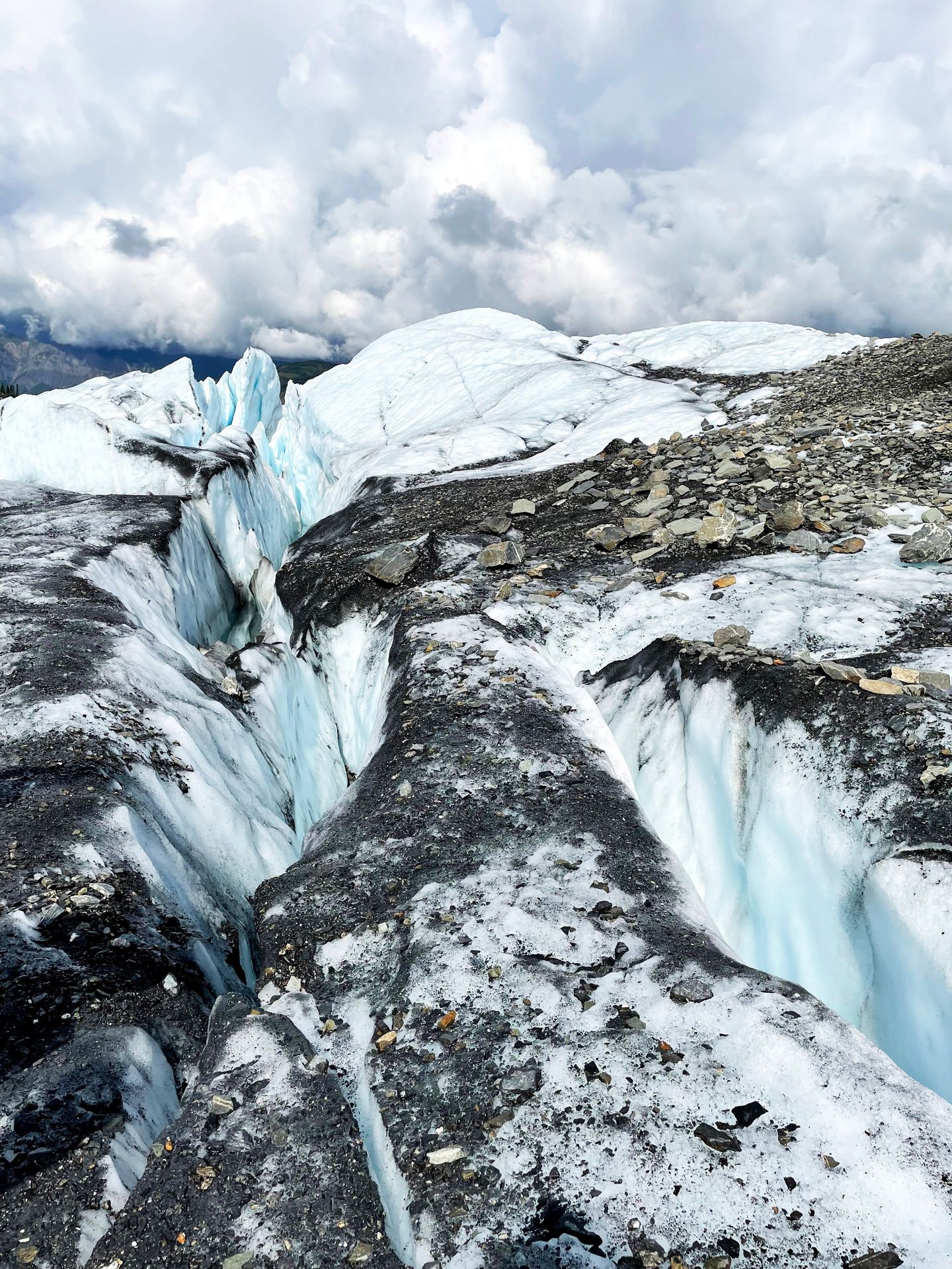 Walking on top of Matanuska Glacier with some large crevasses on either side.