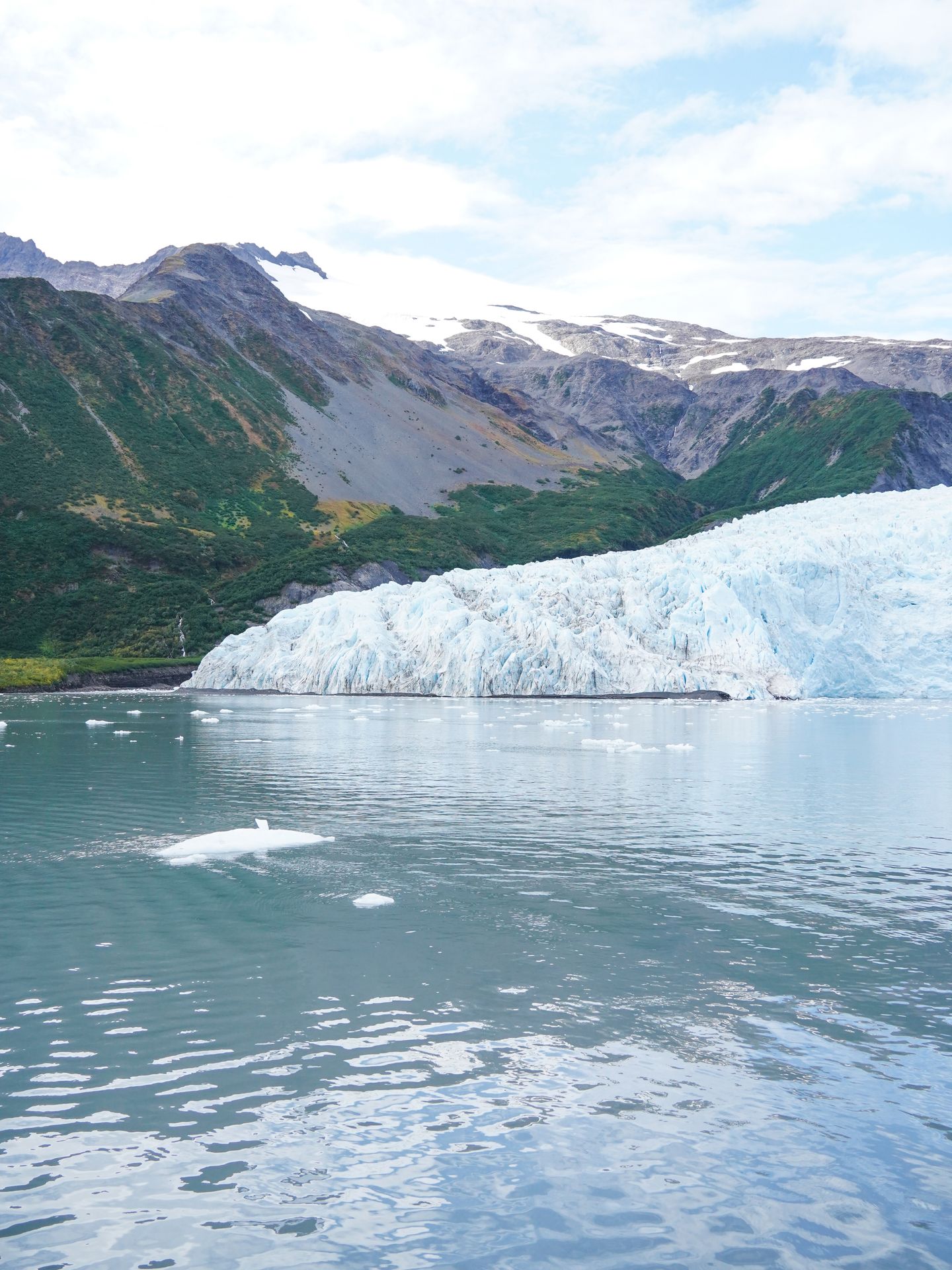 A view of the Aialik Glacier with a mountain behind it, seen from a boat tour with Major Marine