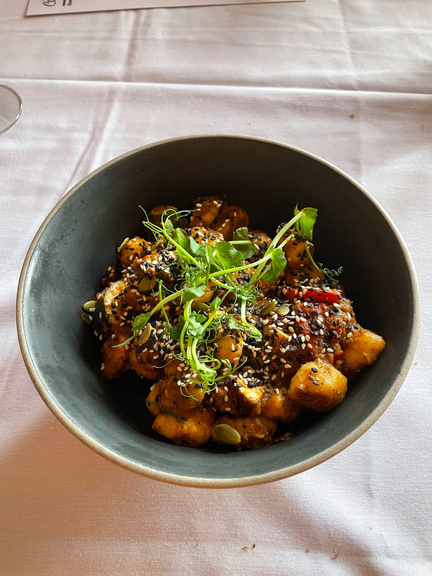 A bowl of gnocchi, sauce and greens in The Maple Leaf.