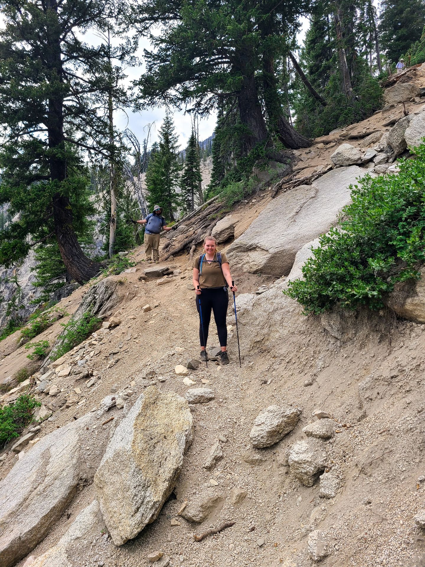 Lydia hiking down a steep, scree area on the Goat Lake Trail.