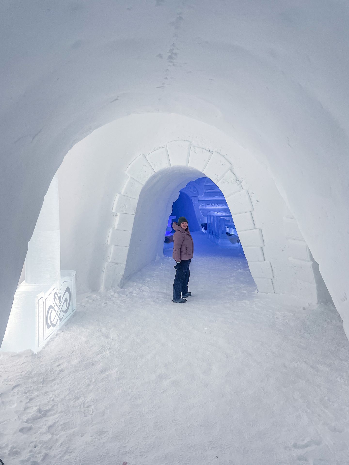 Lydia walking through the ice domes, with a giant ice hammer next to her