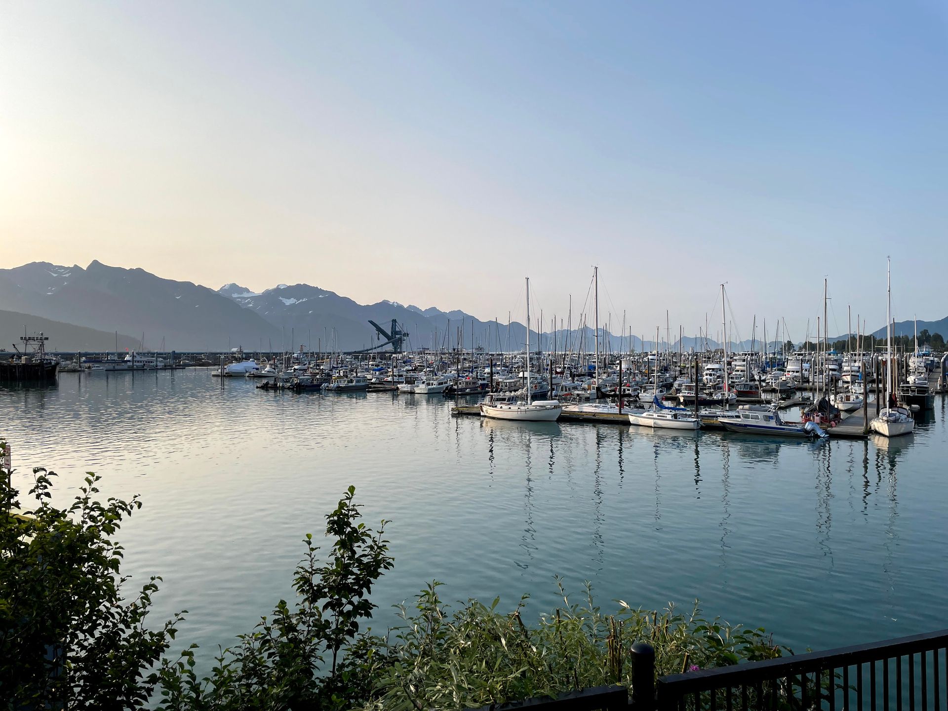 A harbor with several boats and mountains in the distance in Seward.