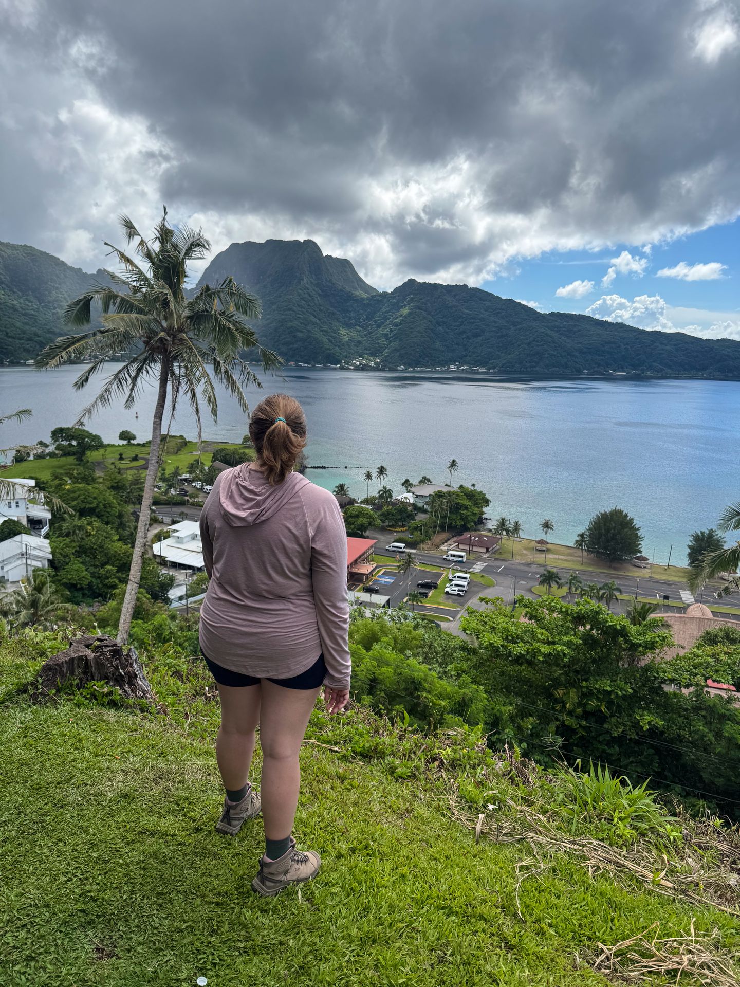 Lydia standing and looking out at Pago Pago Harbor from the Aerial Tramway view