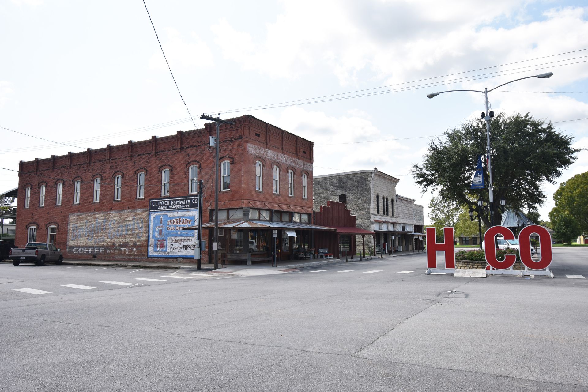A view of downtown Hico. Large red letters spell H-C-O with the intenion for you to stand in place of the I.