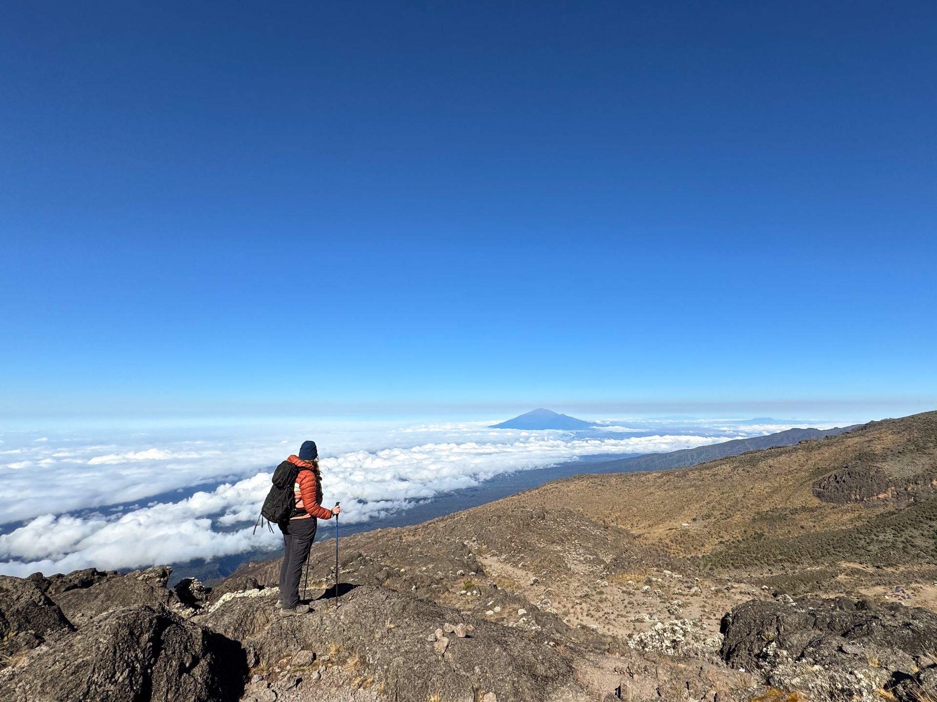 Lydia looking out a mountain and a cloud inversion on the way up to Kilimanjaro