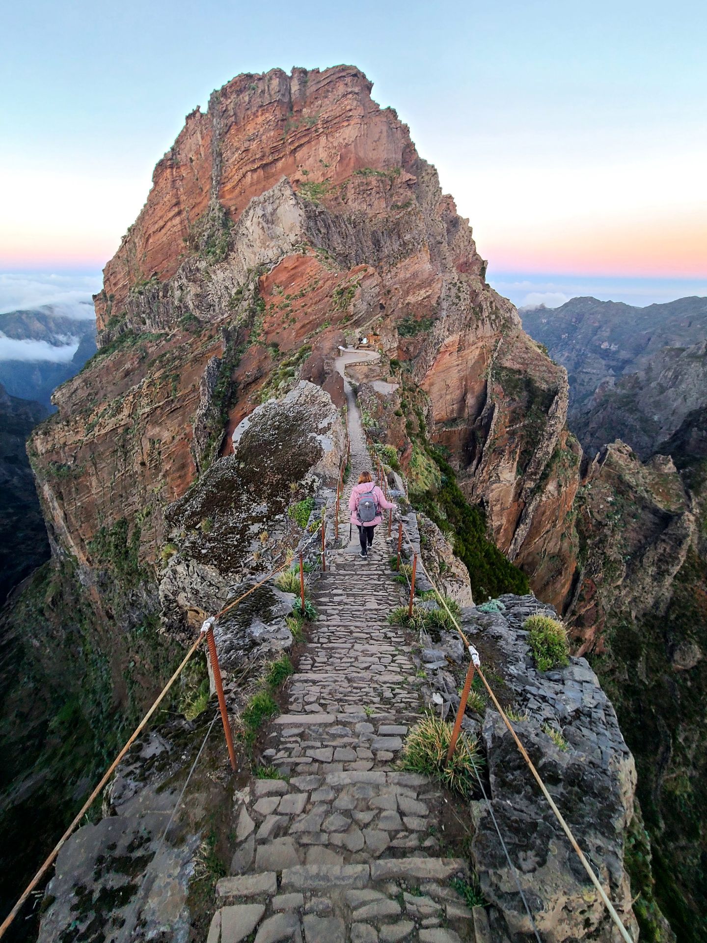 Lydia hiking away on the PR1 trail. There are steep drop offs on both sides of the trail.