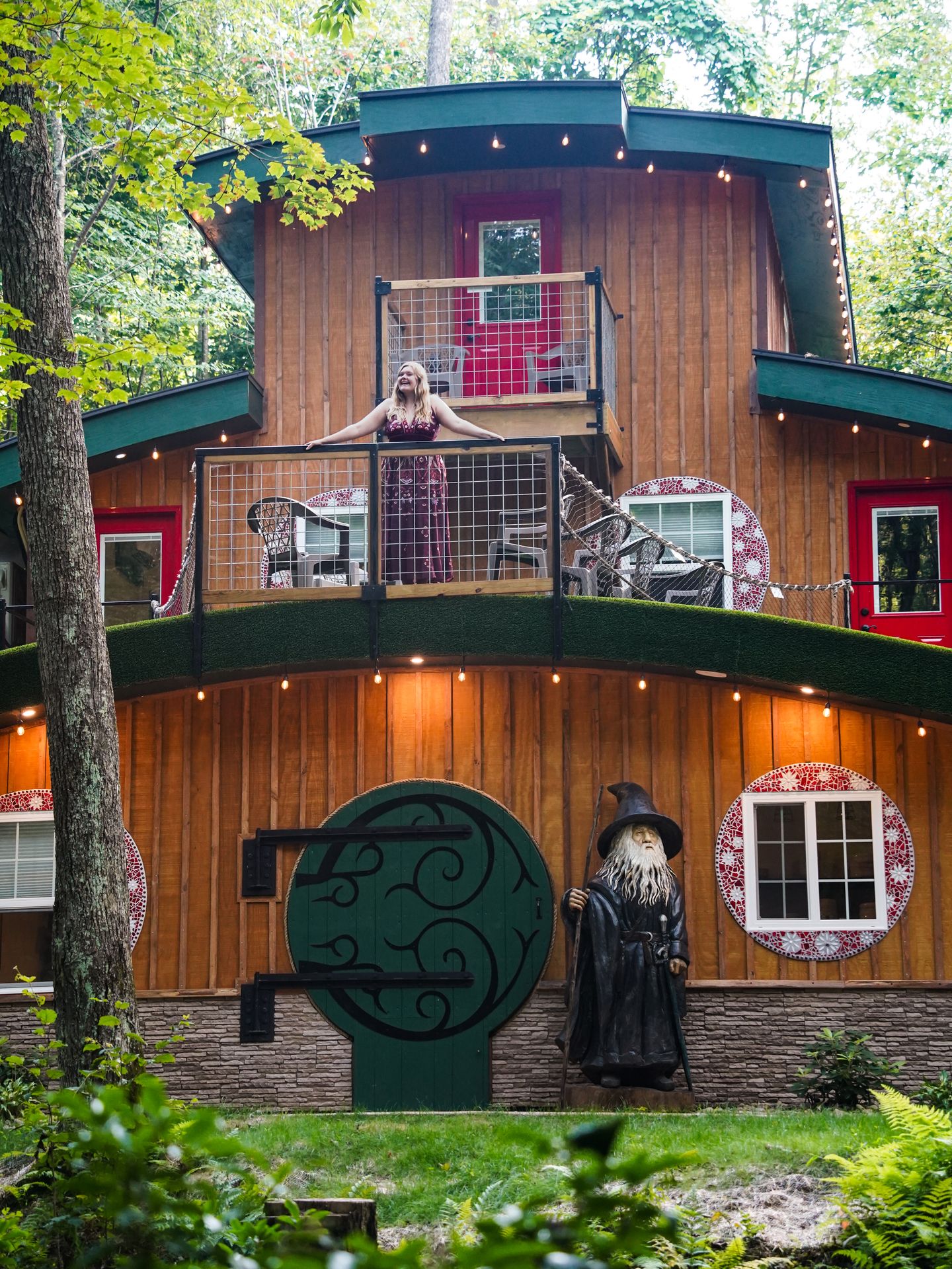 Lydia standing on a balcony on top of The Hobbit House in the Laurel Highlands.
