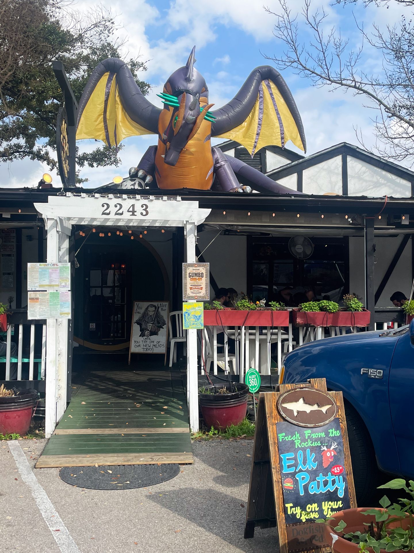 The exterior of Hobbit Cafe, where there is a giant blow-up dragon on the roof