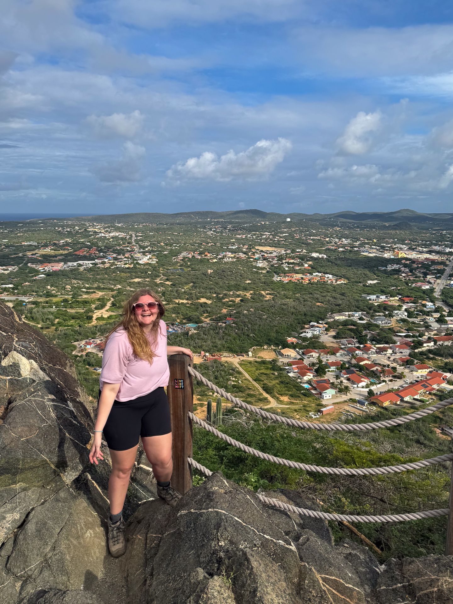 Lydia at the top of Hooiberg Mountain, with views of the island in the background