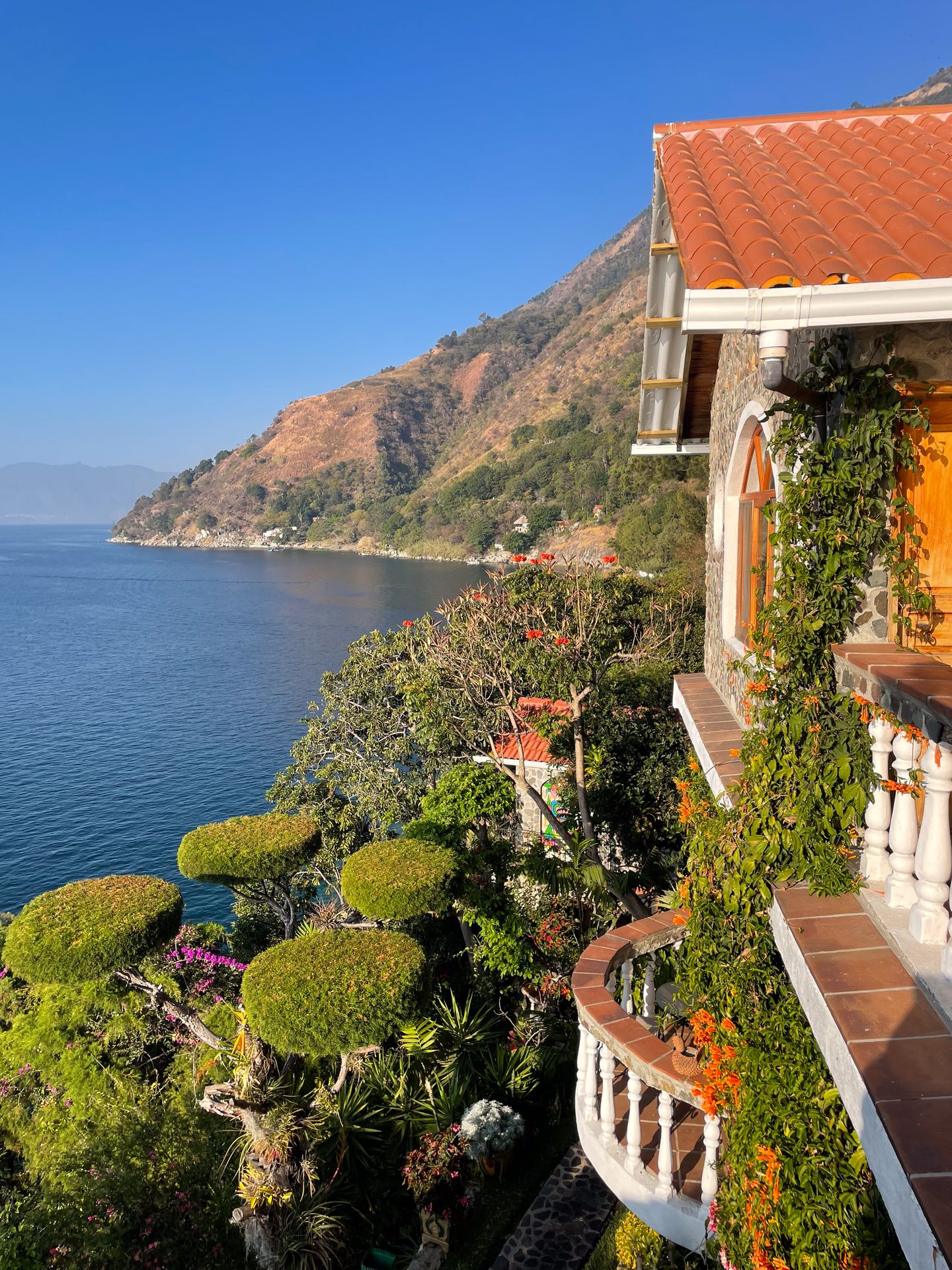 A view of La Casa del Mundo, which sits on the edge of a cliff and has lots of beautiful greenery
