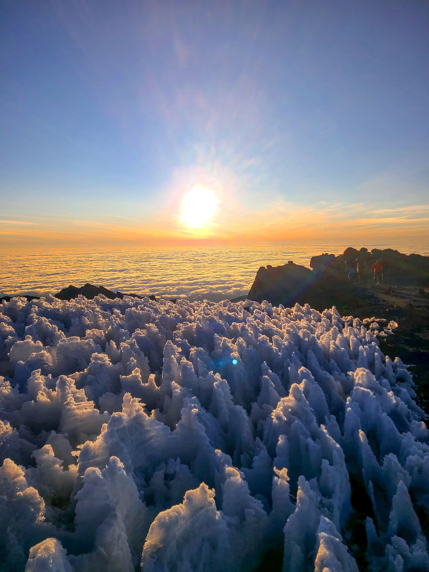 Ice formations with a cloud inversion at sunrise, seen from the top of Mt Kilimanjaro