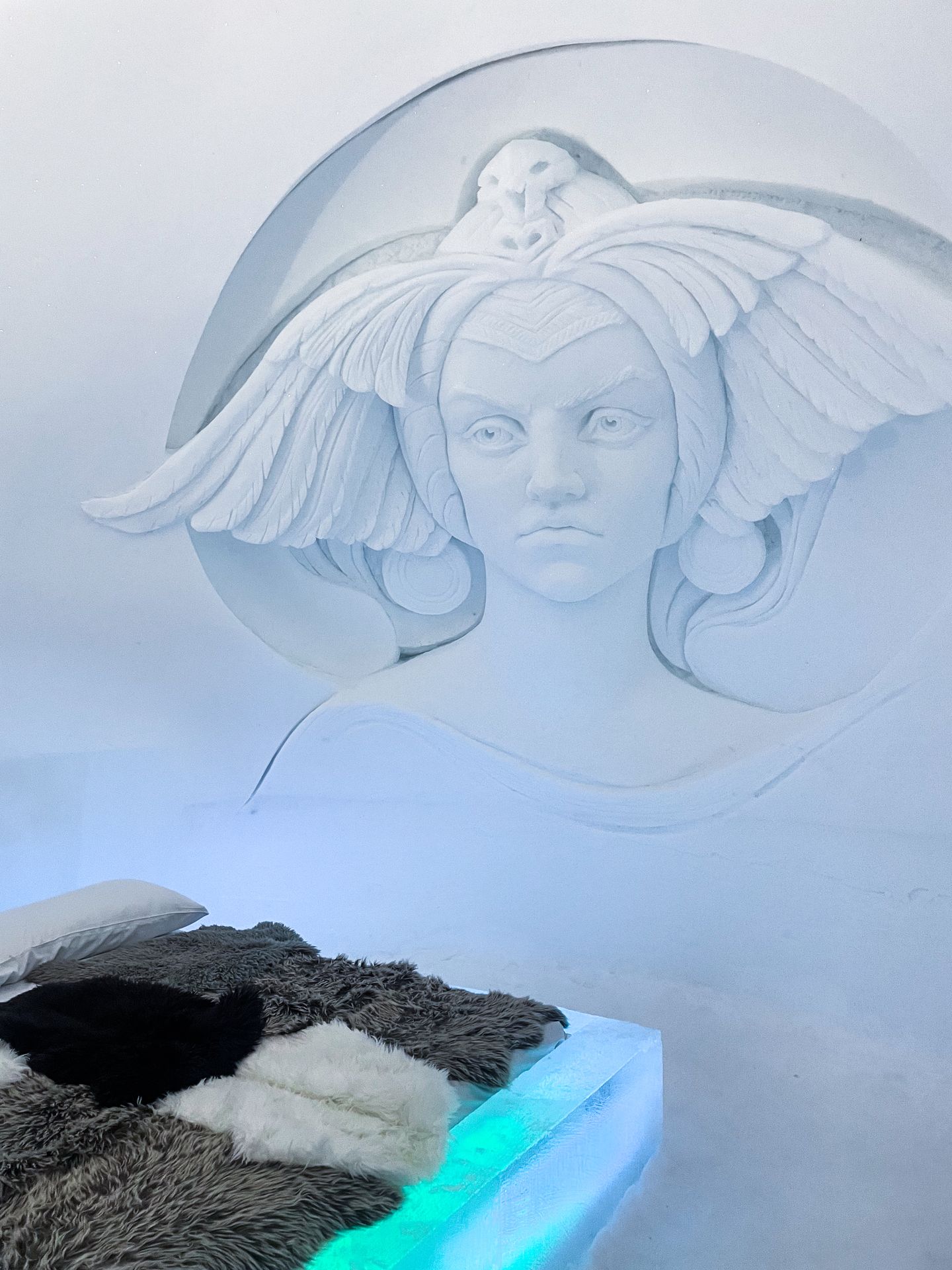 An ice bed with the face of a woman carved on the wall
