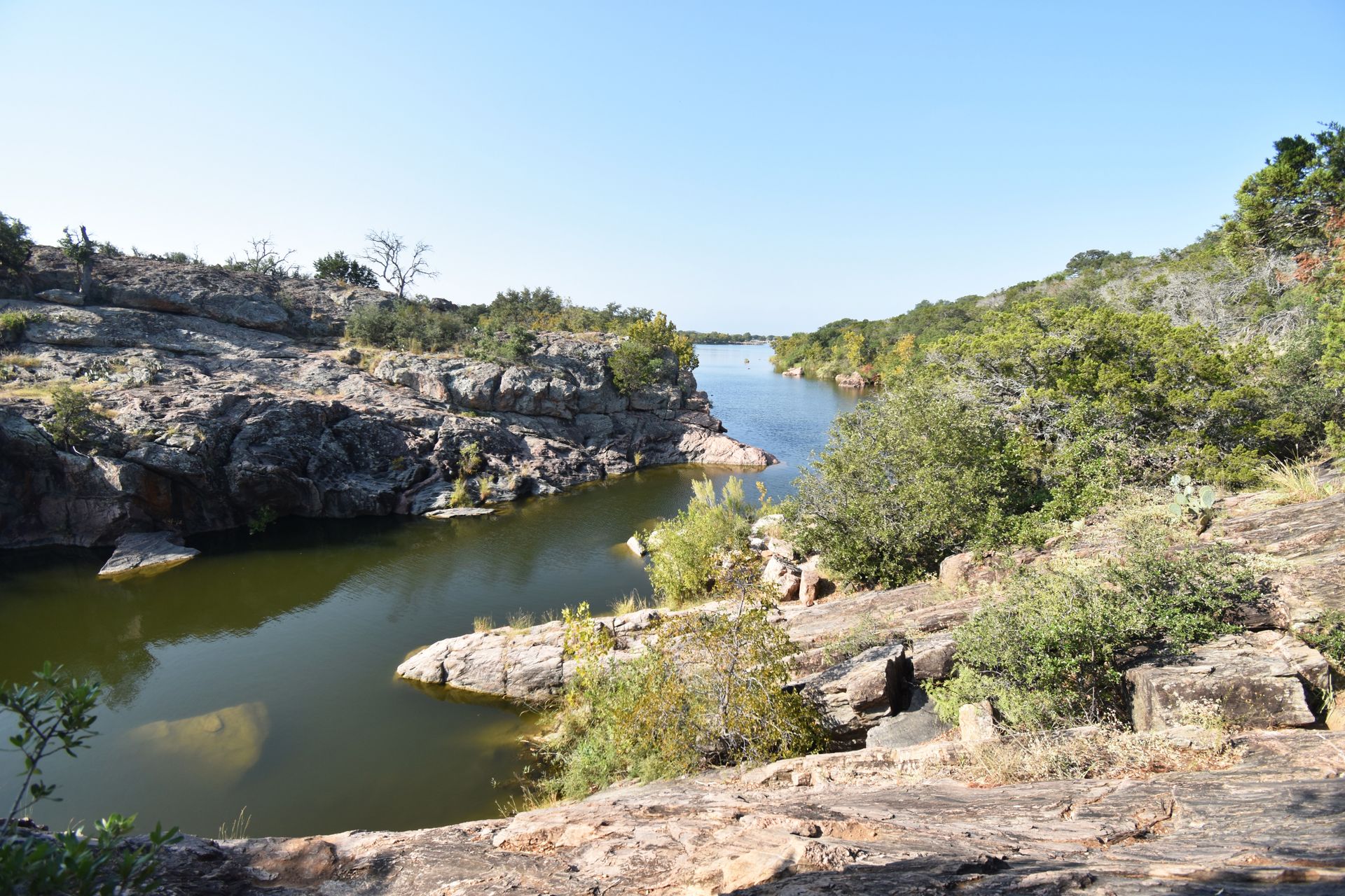 Water curving through some rocks and greenery at Inks Lake.