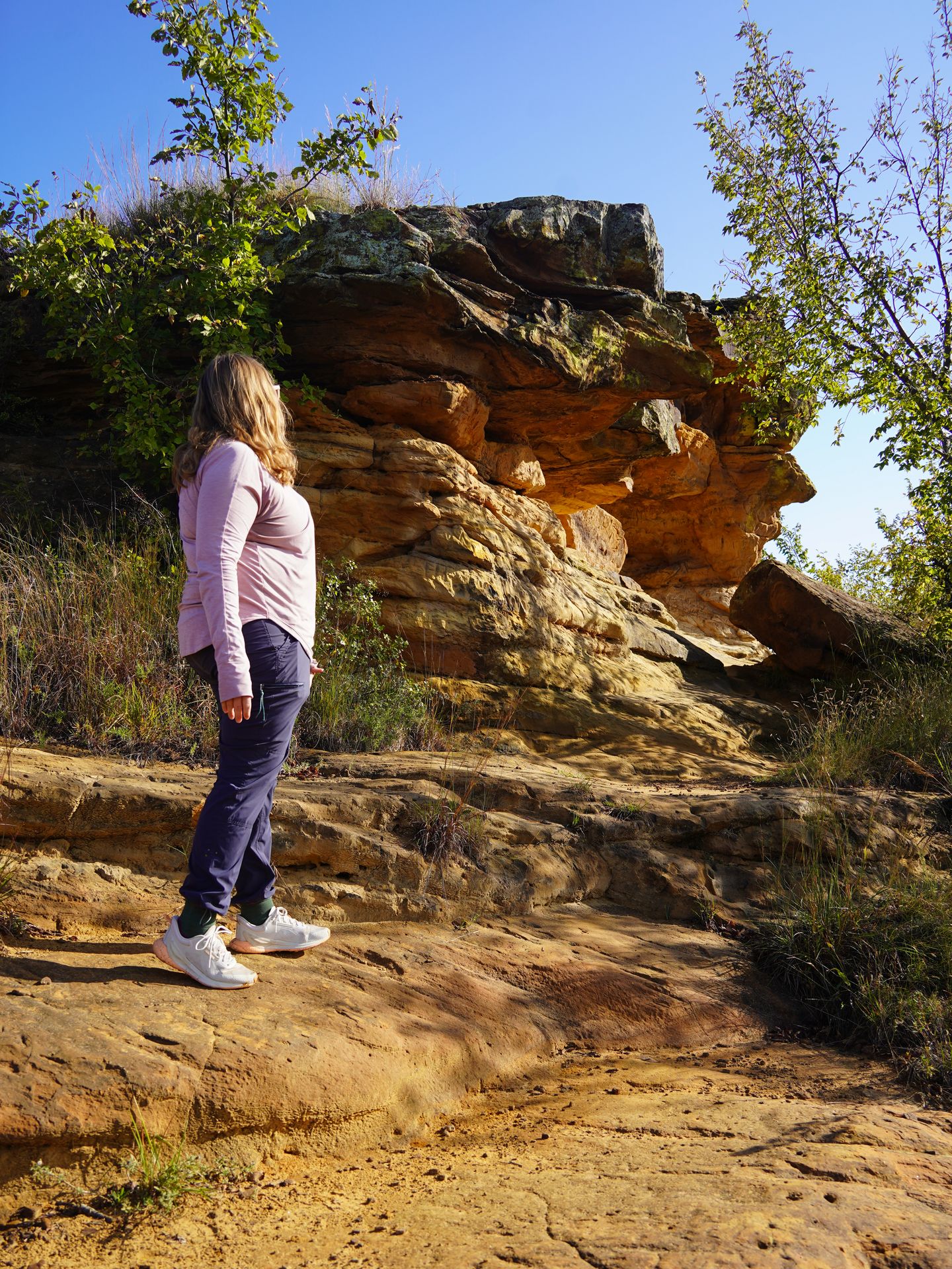 Lydia standing next to a rock formation that resembles the profile of a face