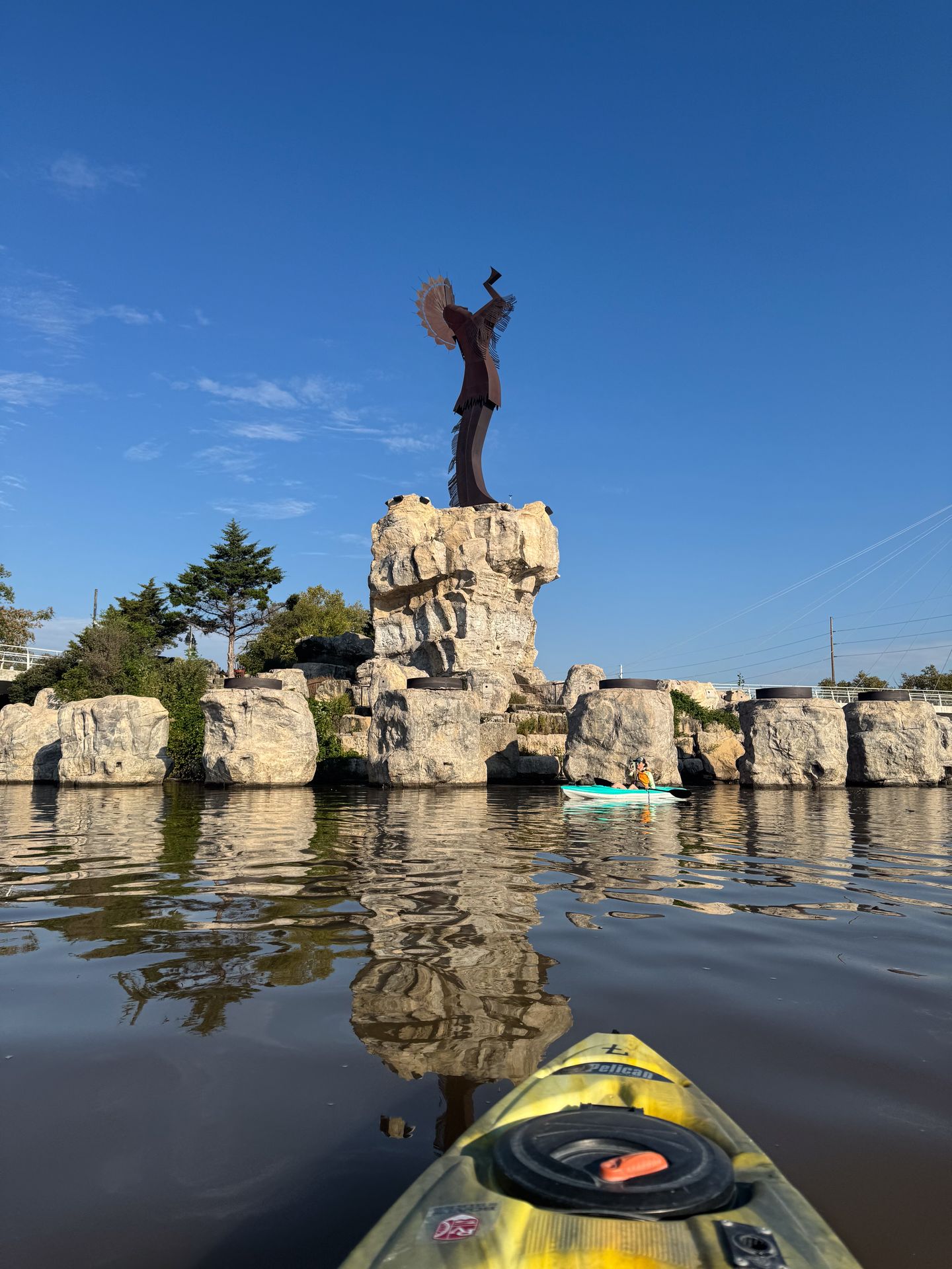 The view from a kayak on the water next to the Keeper of the Plains statue in Wichita