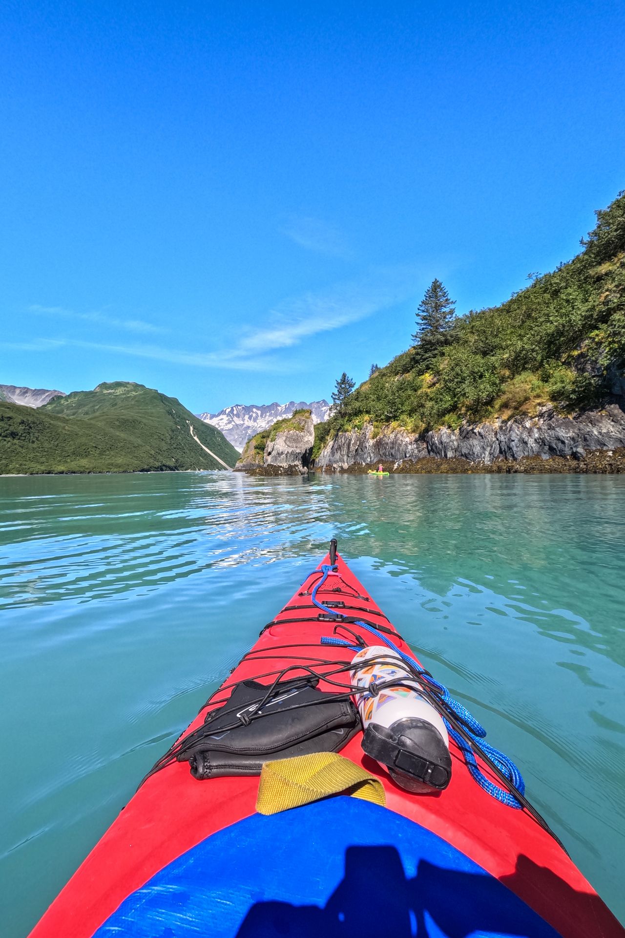 Looking out from the front of a kayak while kayaking in Kenai Fjords National Park