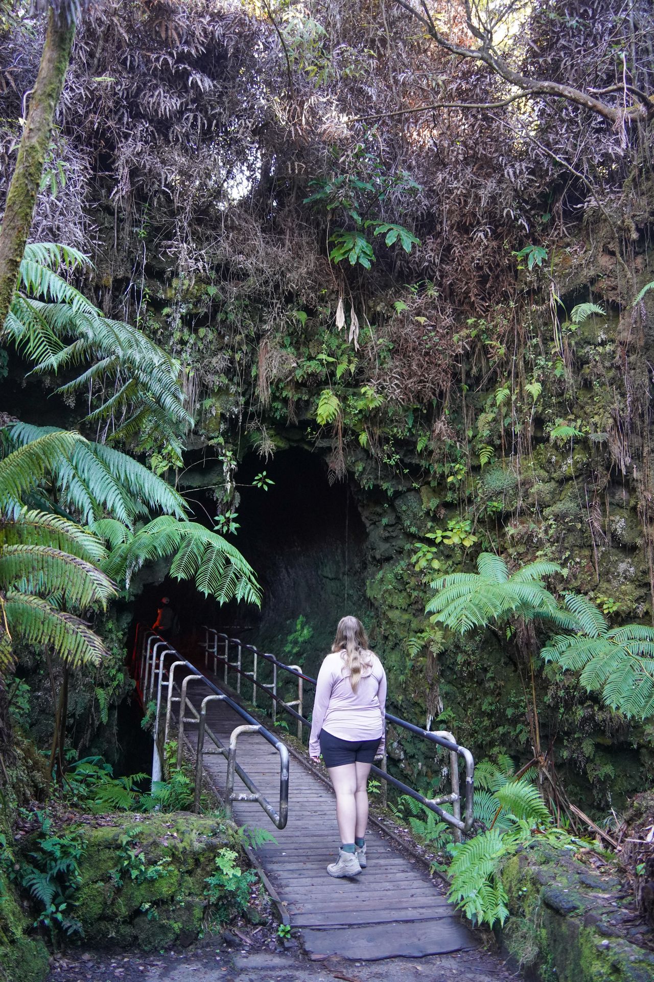 Lydia standing at the entrance of the Thurston Lava Tube in Hawaii Volcanoes National Park