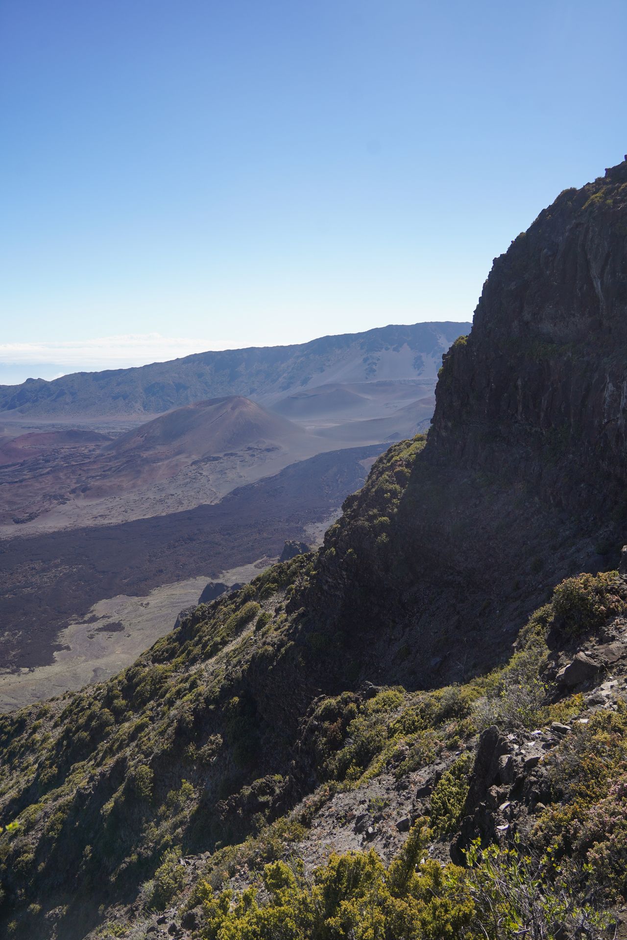 A cliff and clouds hanging low among the rocks