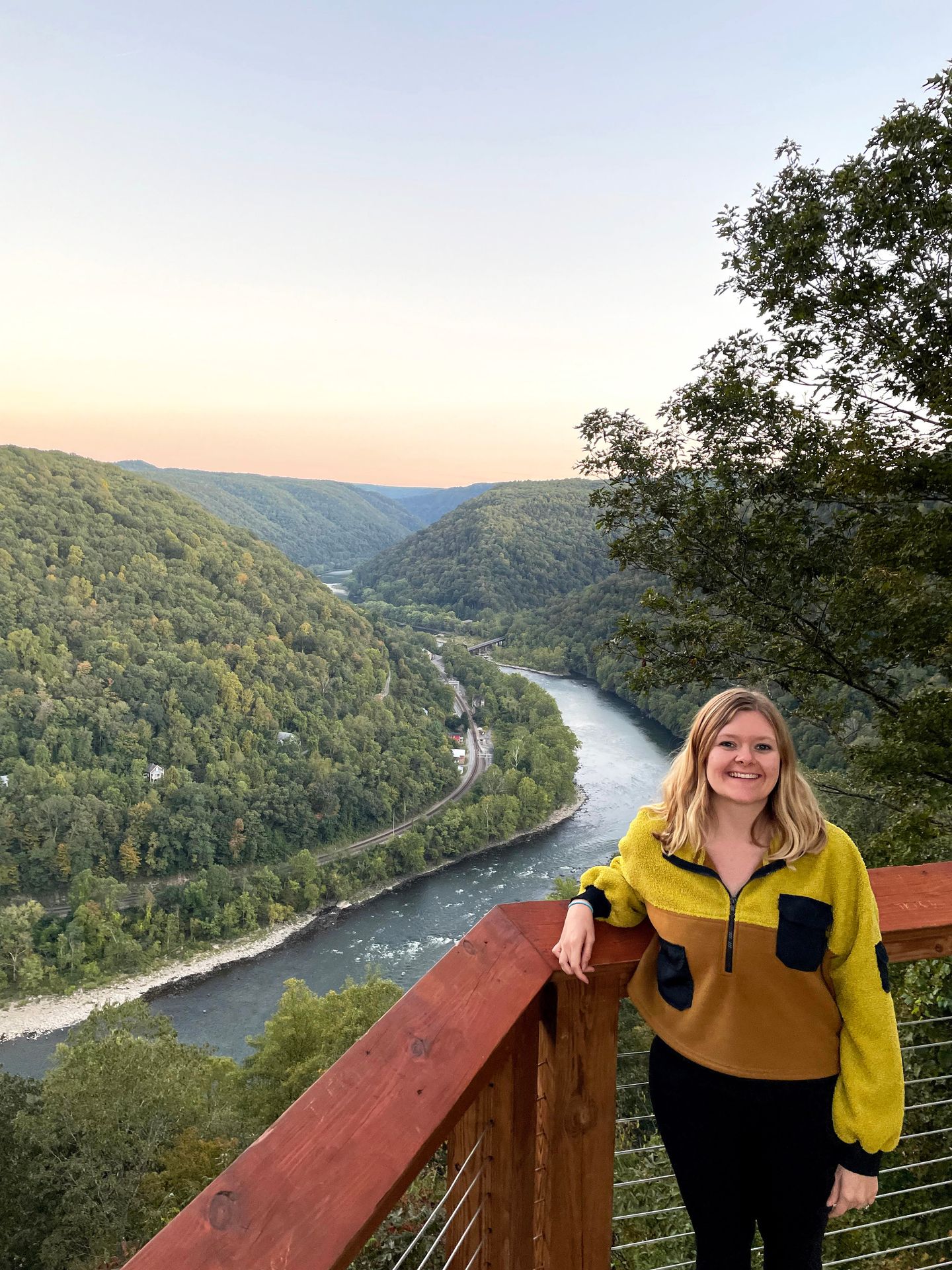 Lydia standing against the fence at the Concho Rim Overlook.