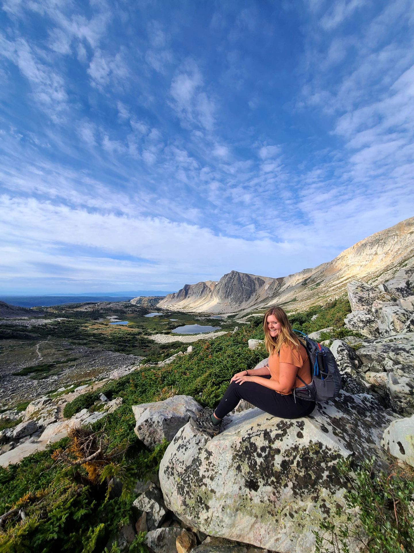 Lydia sitting on rocks on the hike to Medicine Bow Peak
