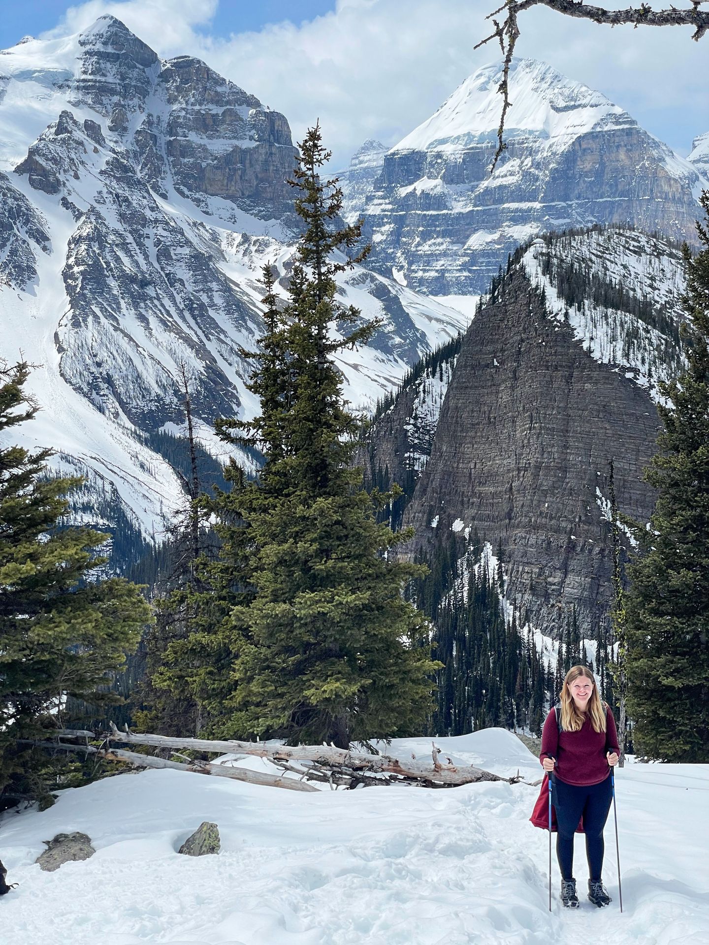 Lydia on a snow-covered hiking trail with a mountain background.