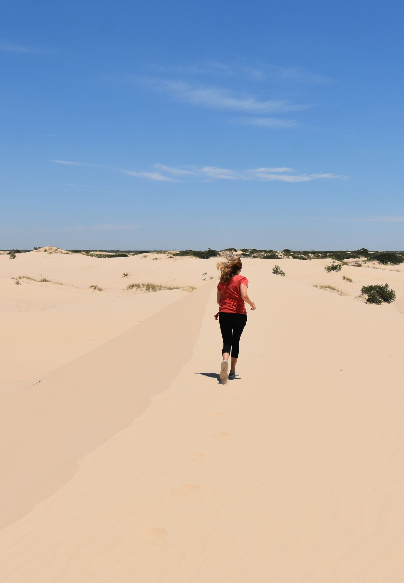 Lydia running away in the Monahan Sandhills.