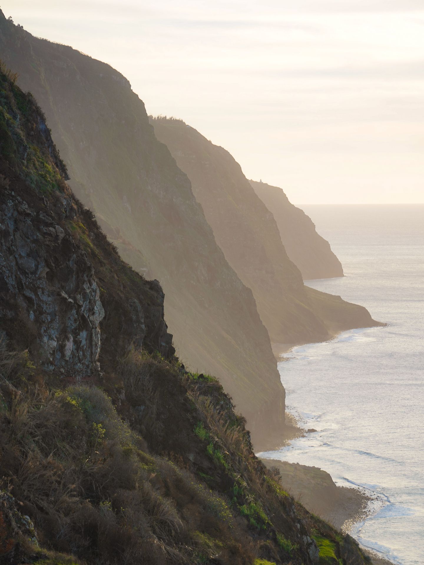 Looking at layers of mountains on the water as the sun sets