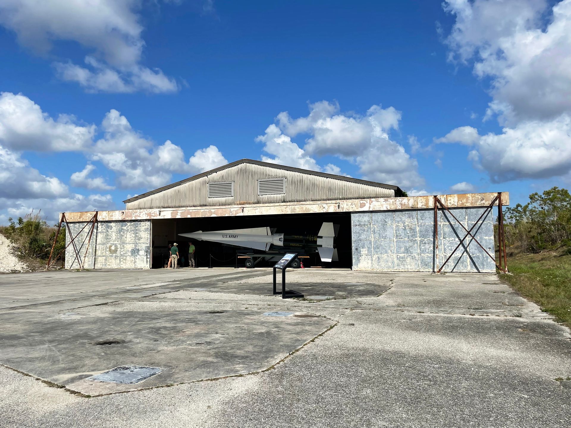 A building with garage doors open to reveal a missile labeled US Army.