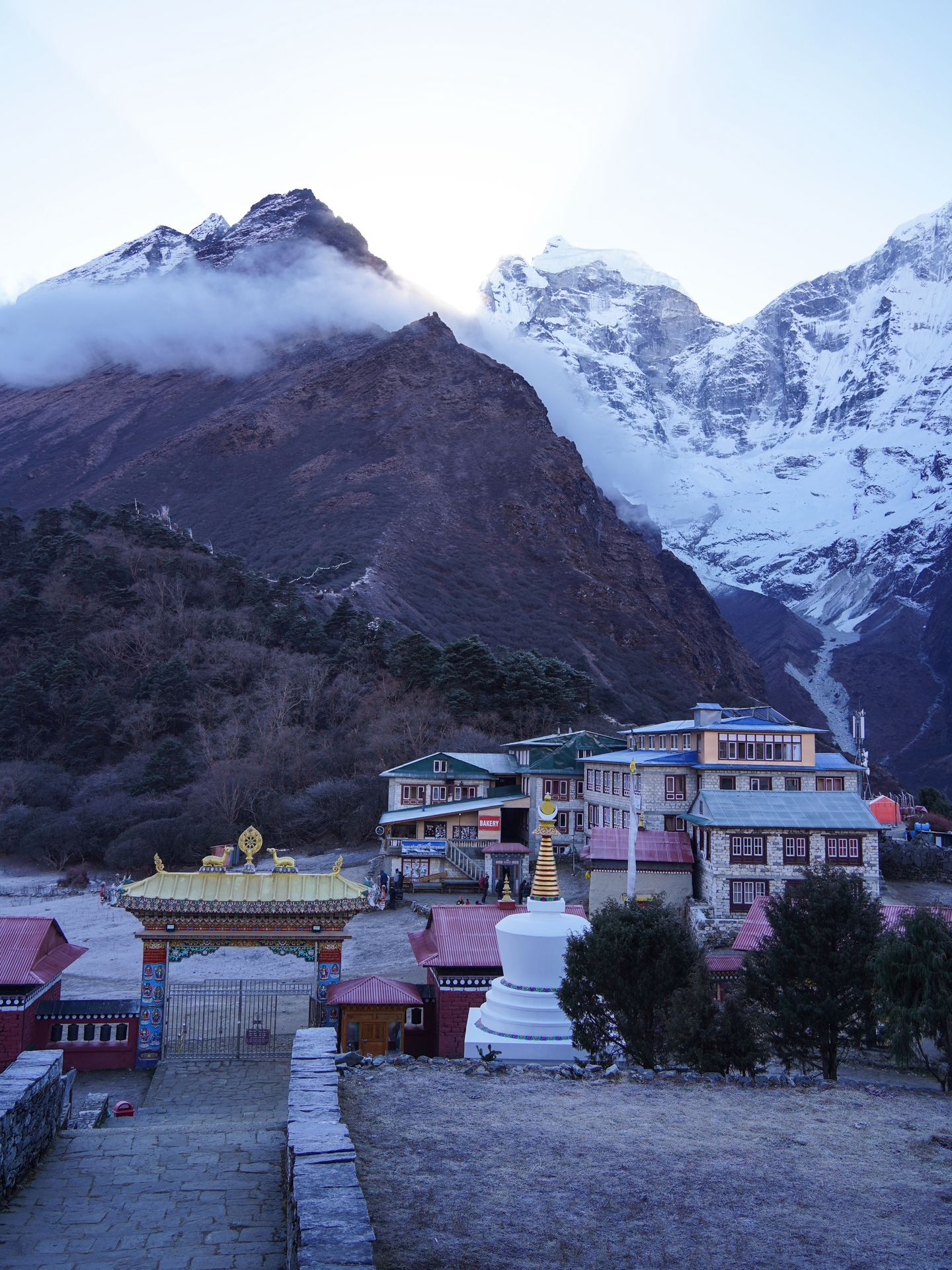 Looking at the mountains and surrounding buildings from inside of the Tengboche Monastery