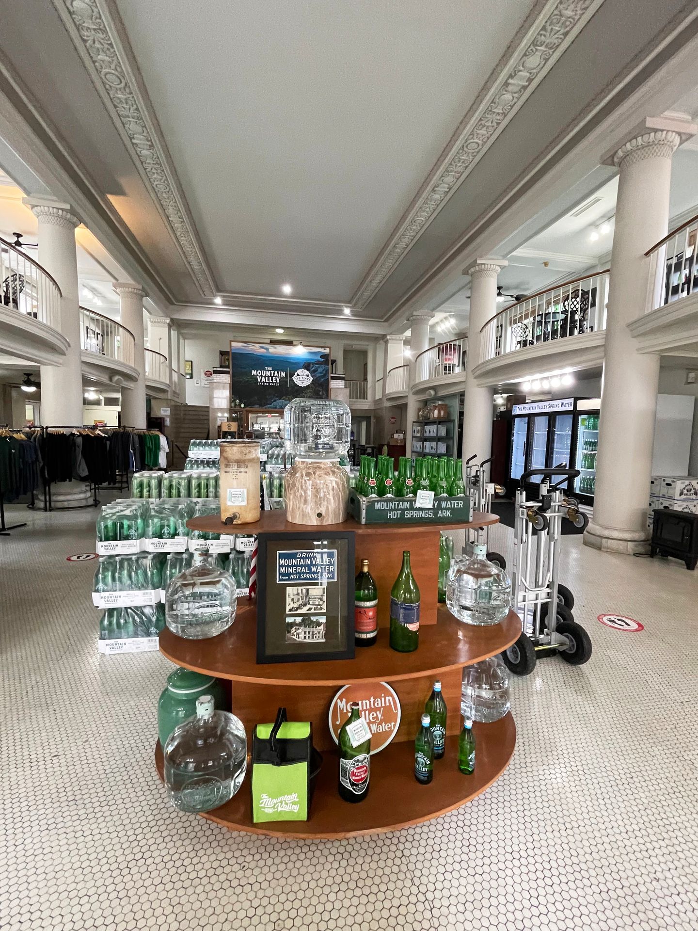 The inteior of the Mountain Valley Water shop. There are glass bottles of water and other gift items for sale.