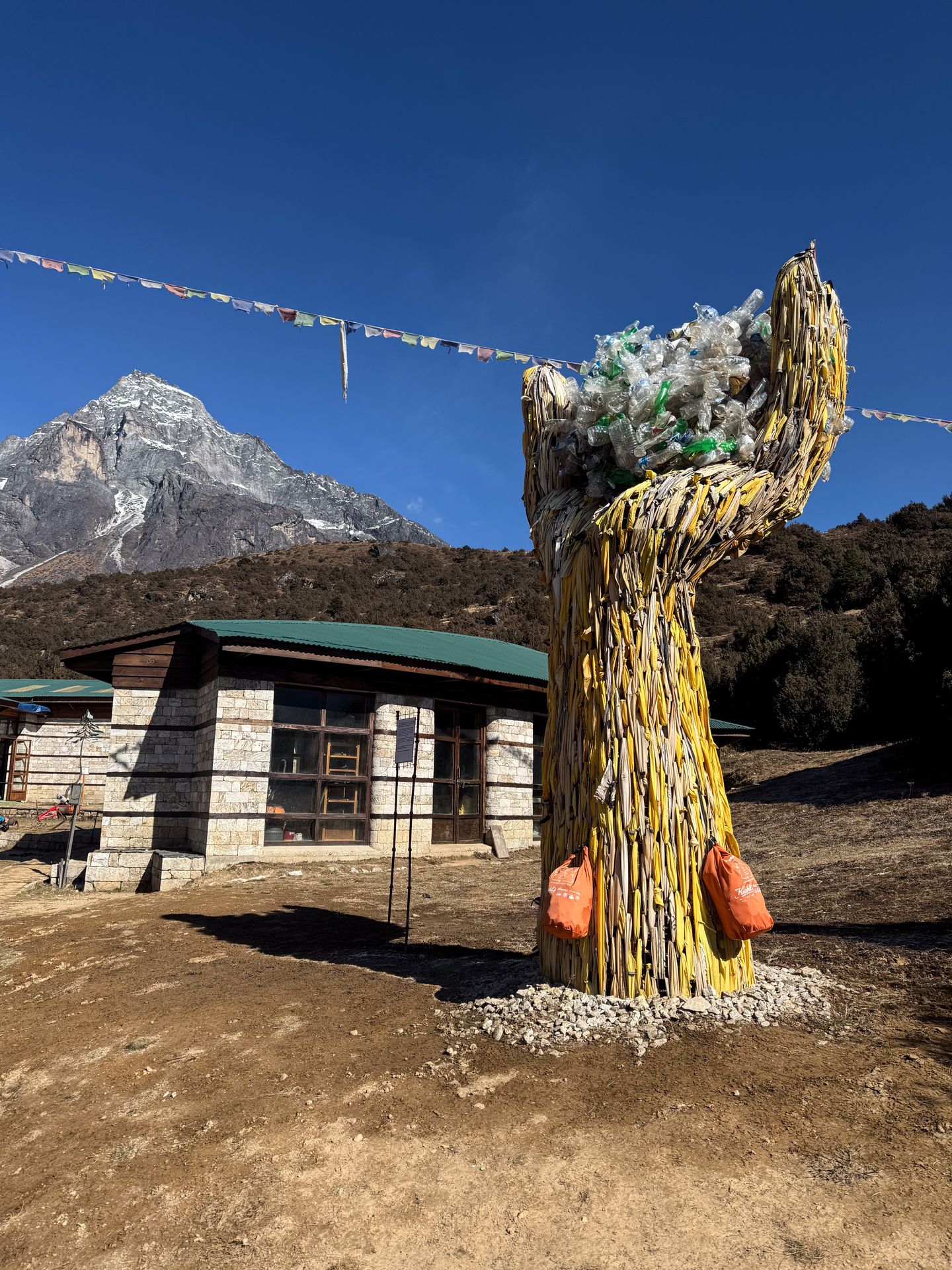 A large arm and fist made out of trash at Sagarmatha Next