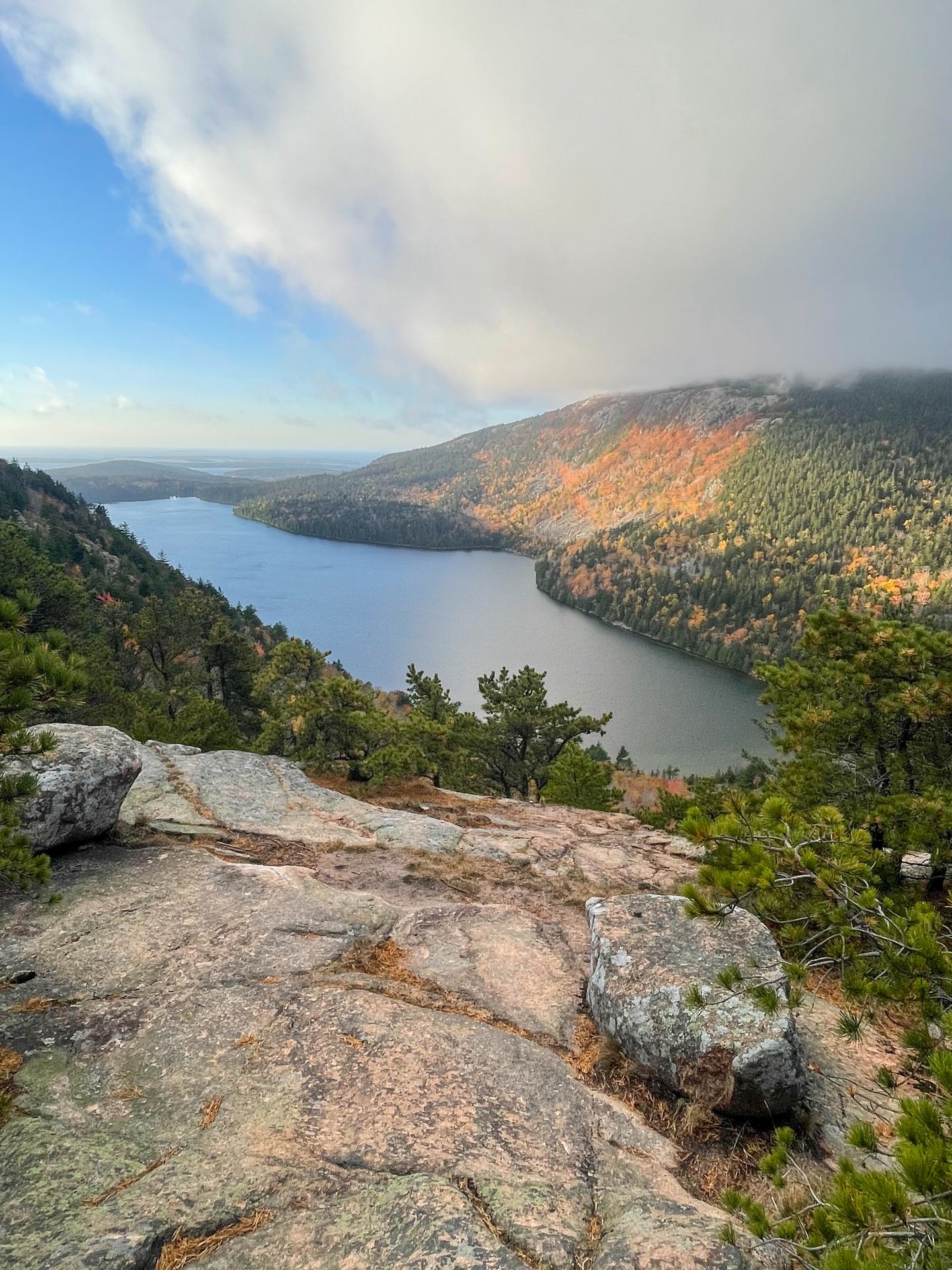 Looking down at a lake from the North Bubble. The mountain is covered with yellow trees.
