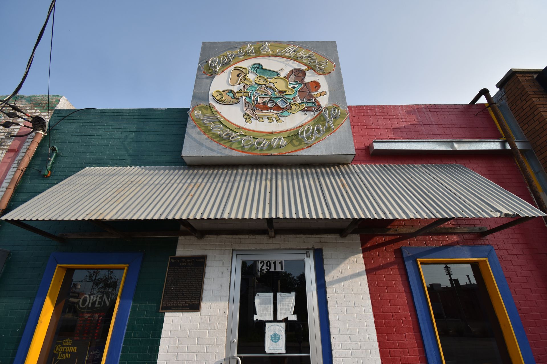The exterior of Pepe & Mito's. The building is painted red, white and green.