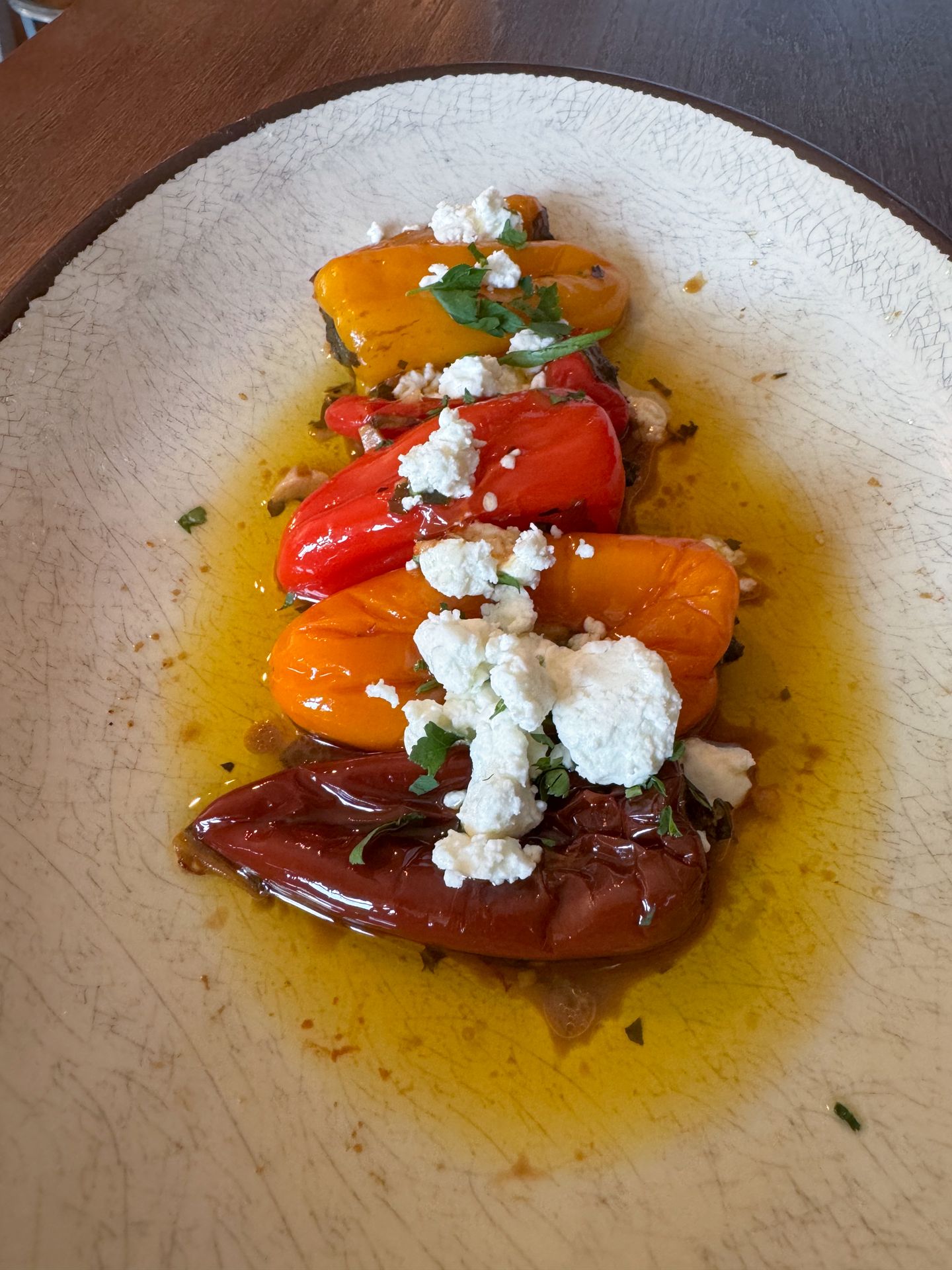 A dish with shishito peppers and cheese from Josephine's