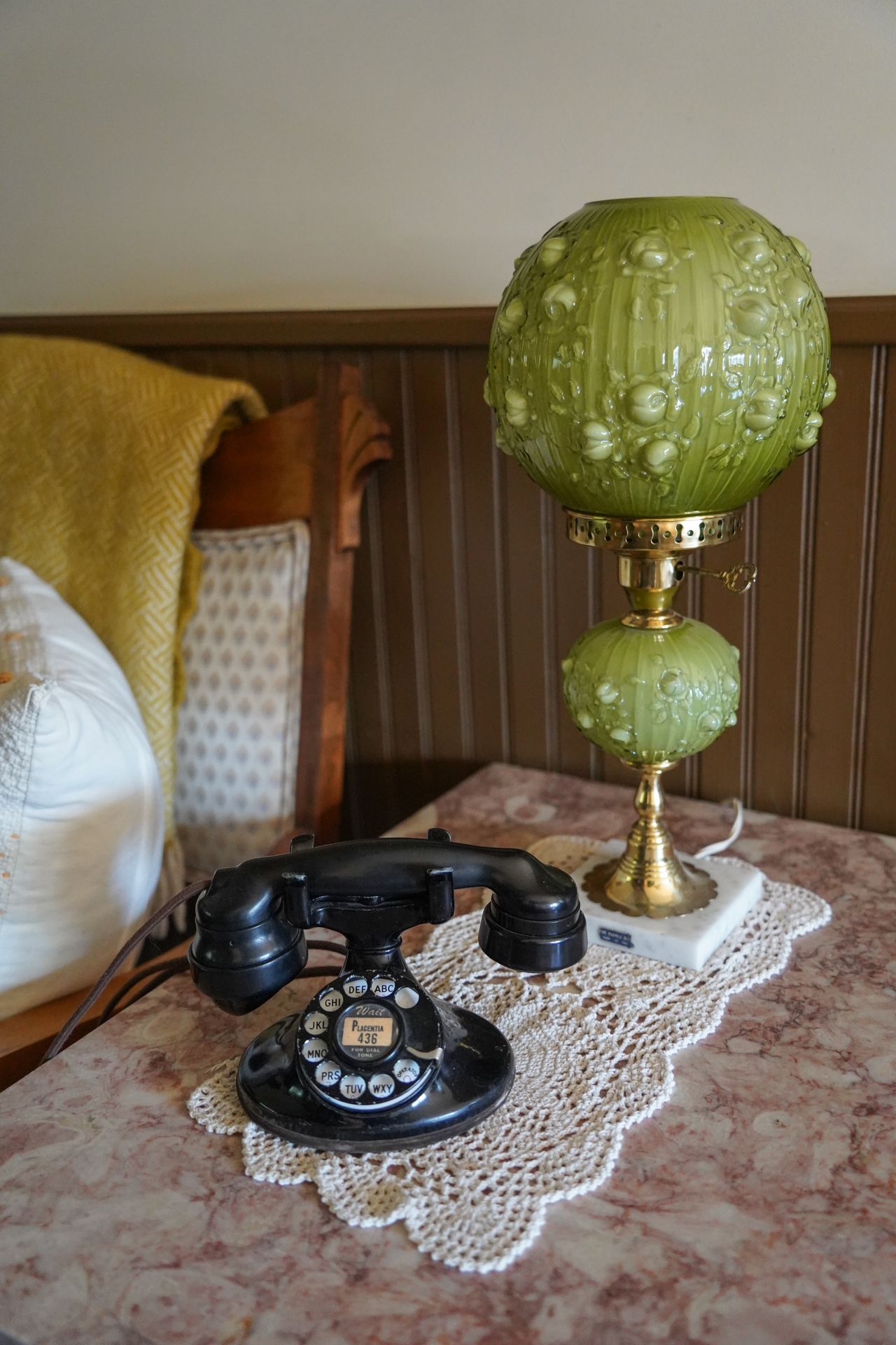 A rotary phone next to a green lamp in the Kate Kennedy House