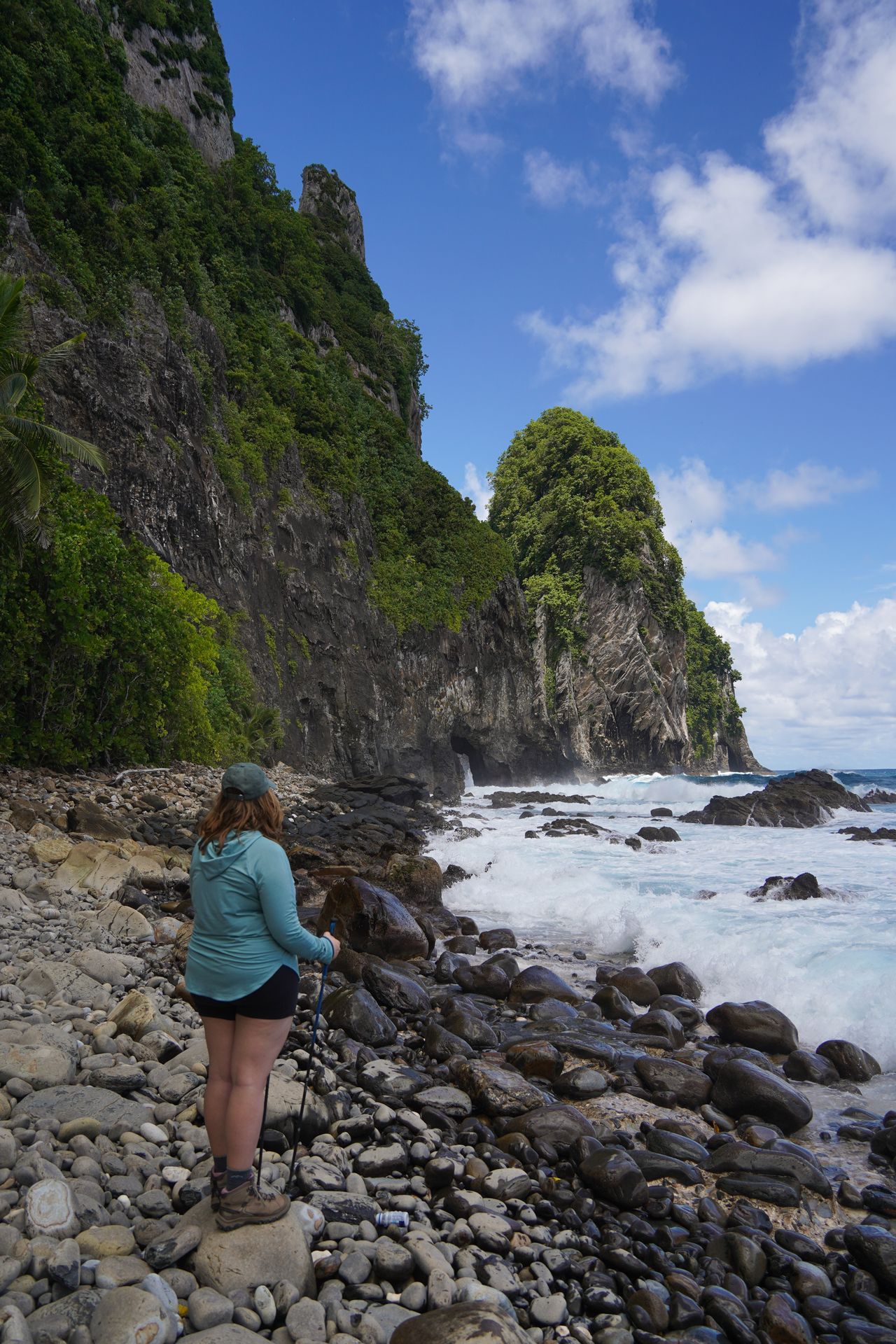 Lydia standing on a rocky beach looking out at Pola Island