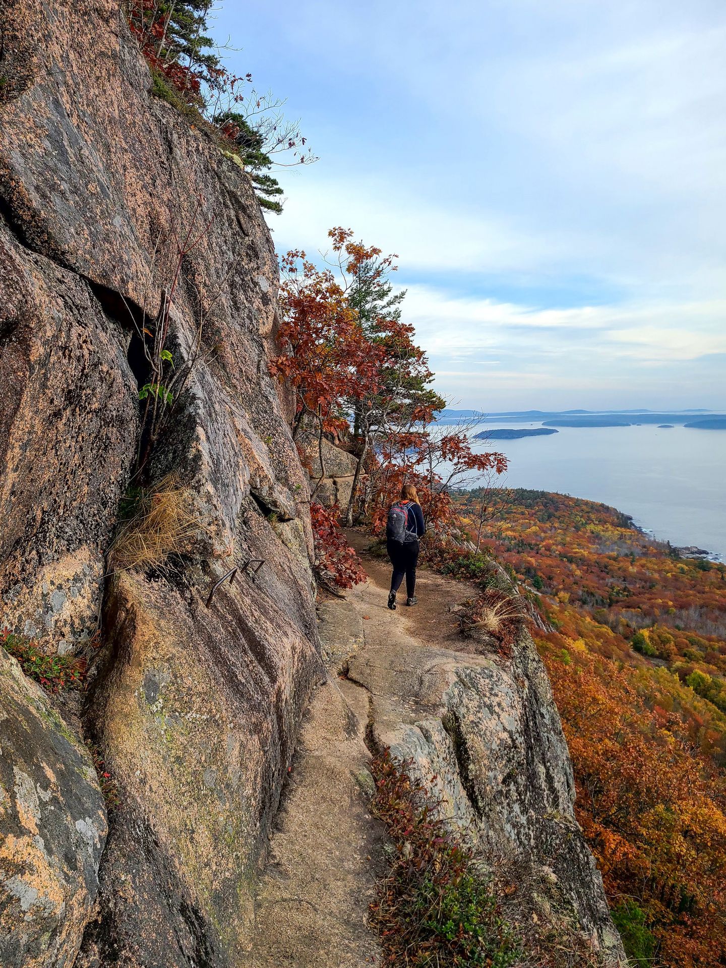 Lydia standing on a cliff looking out at the views from The Precipice Trail