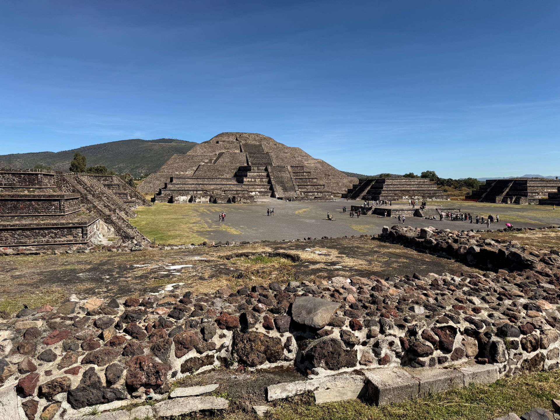 Looking at a pyramid surrounded by smaller stone walls