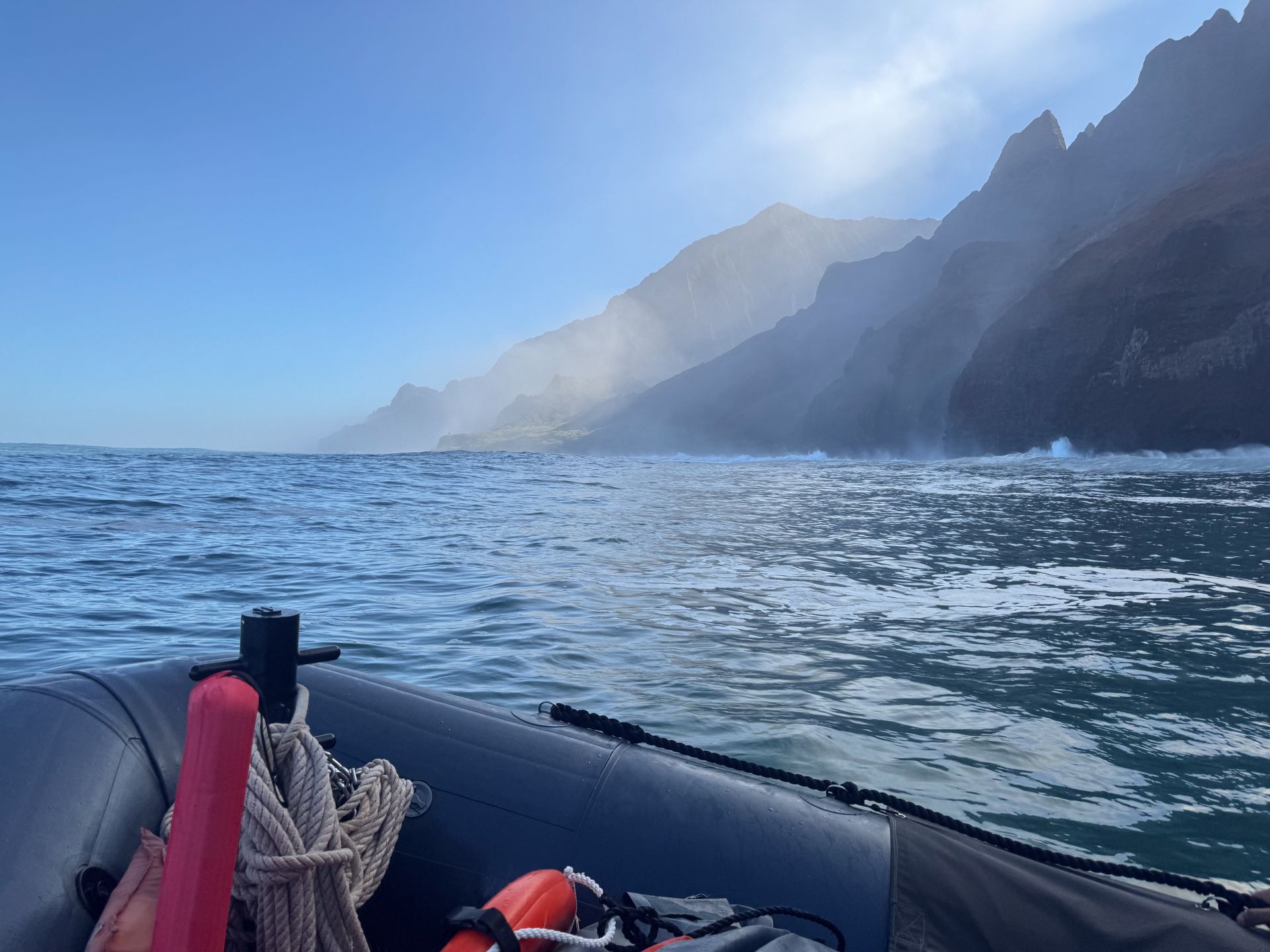 Looking out at the Na Pali Coast from the front of a raft. The coast is obscured by mist