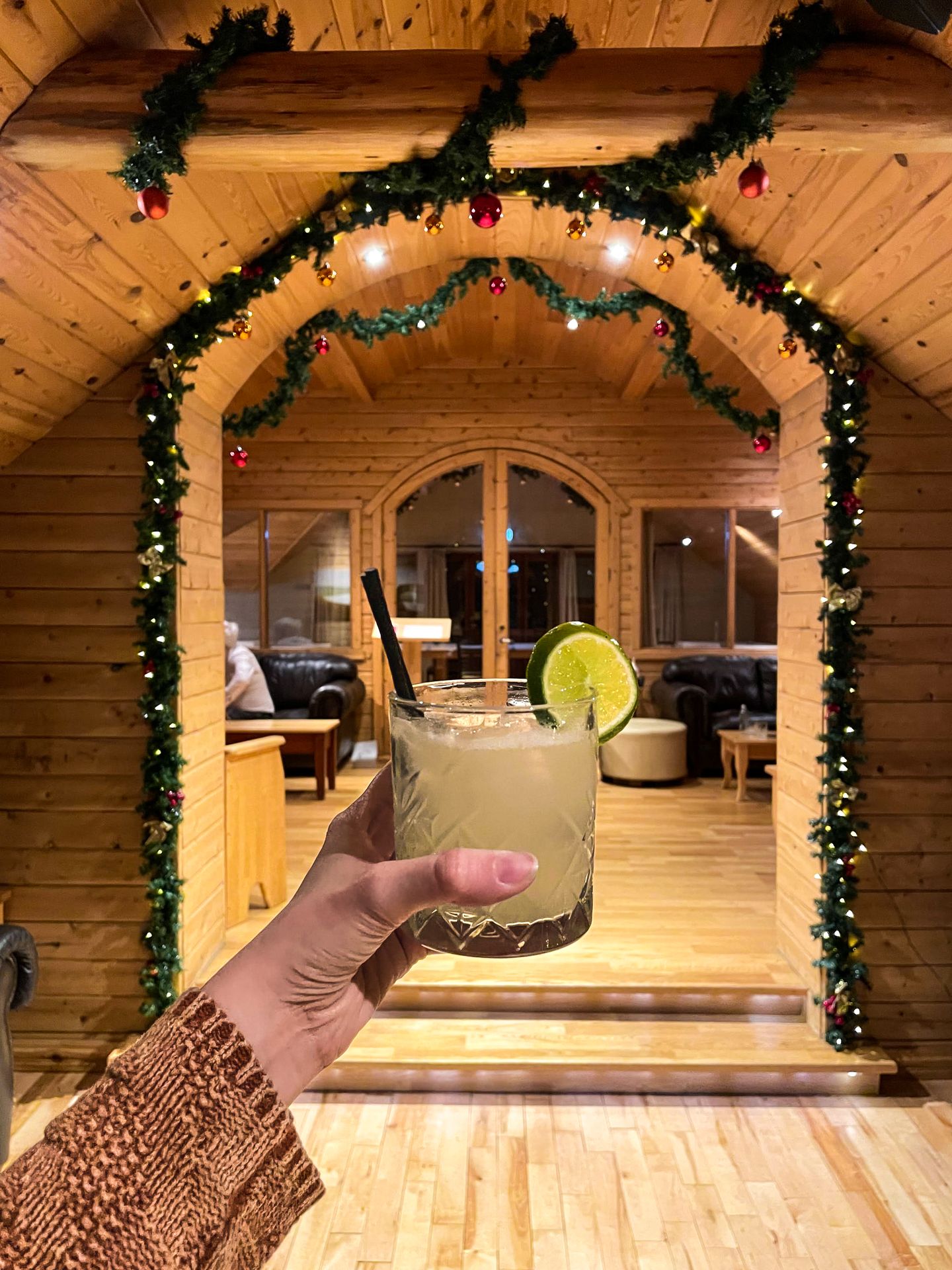 Lydia holding up a cocktail in Hotel Ranga.