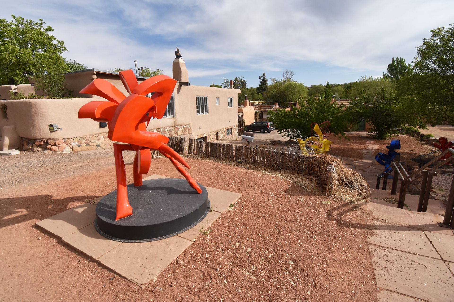 An organically shaped, red sculpture along Canyon Road.