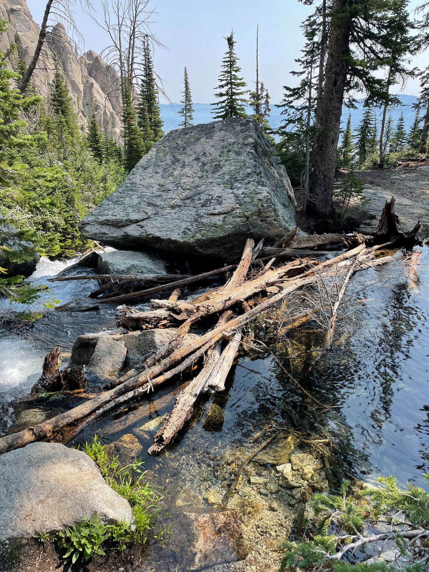 Looking out at Goat Lake, which is a bright blue color. There is a mountain across the lake.