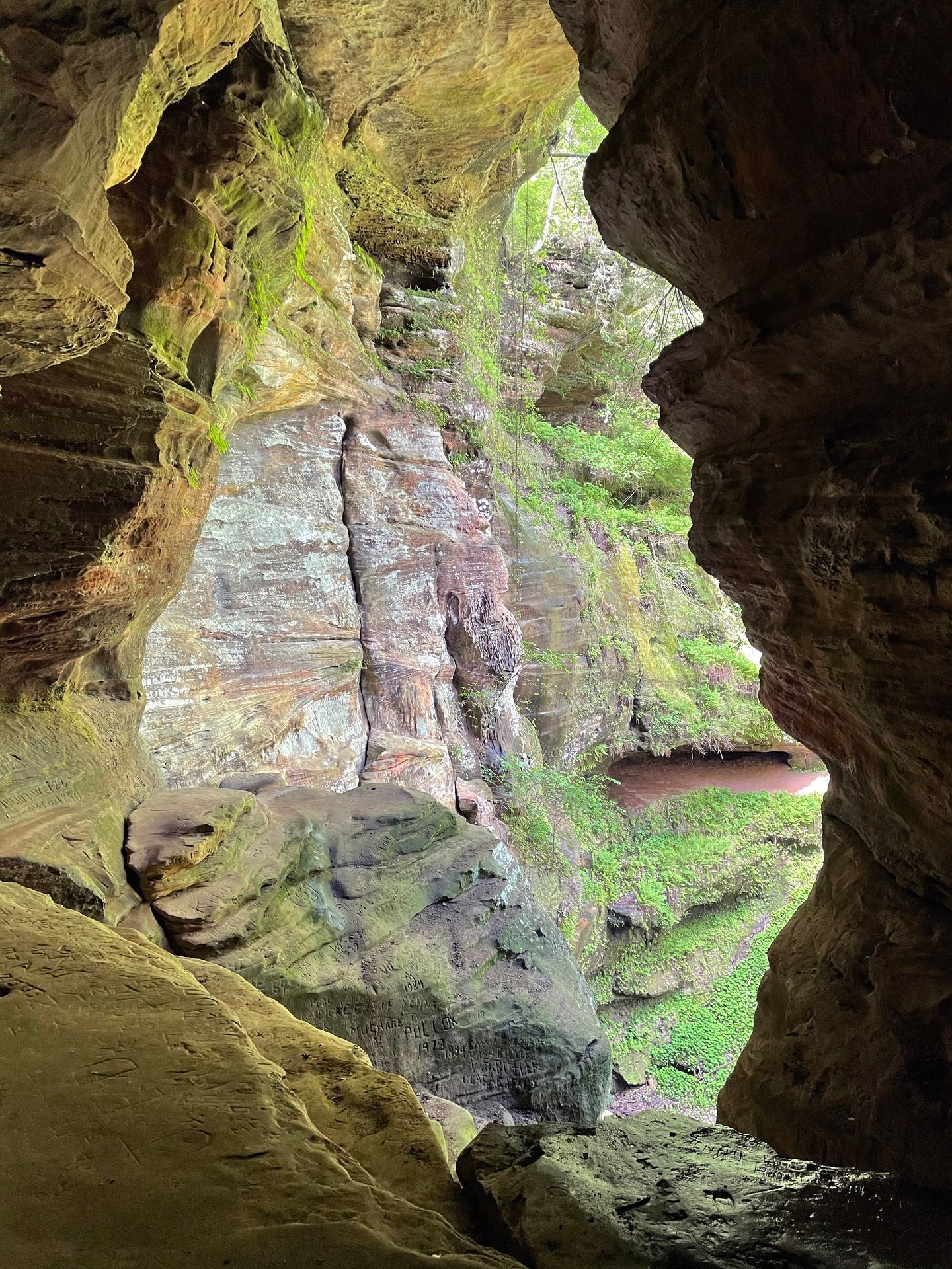 Looking at moss-covered rocks inside of Rock House.