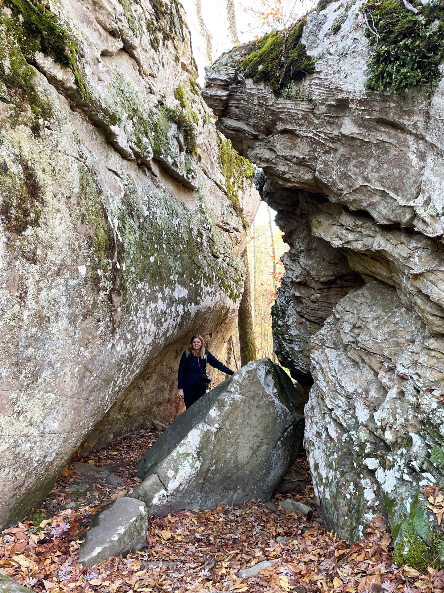 Lydia standing between some giant boulders on the Seven Hollows Trail.