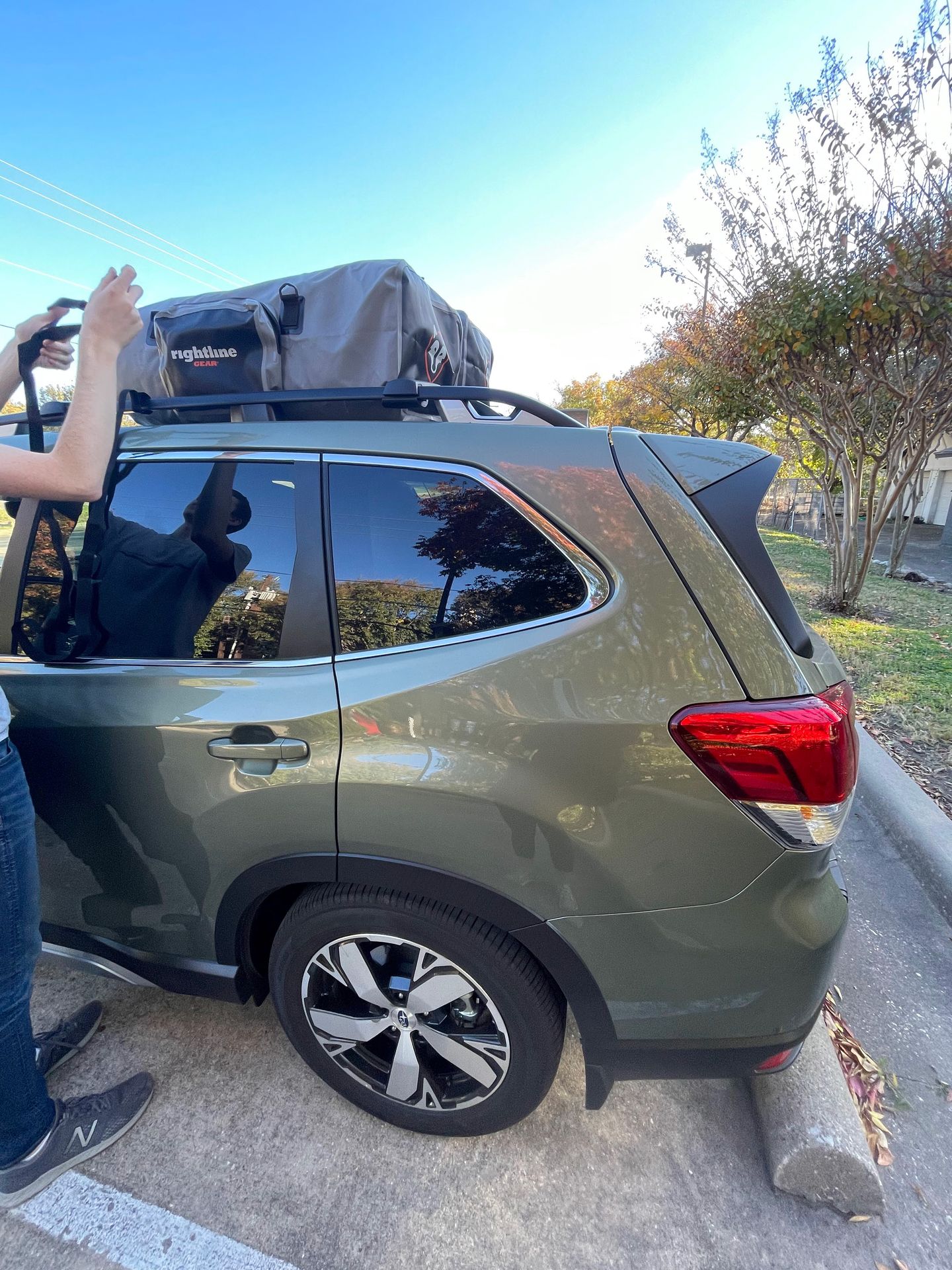 Joe strapping down our soft side rooftop bags to the Subaru Roof rack