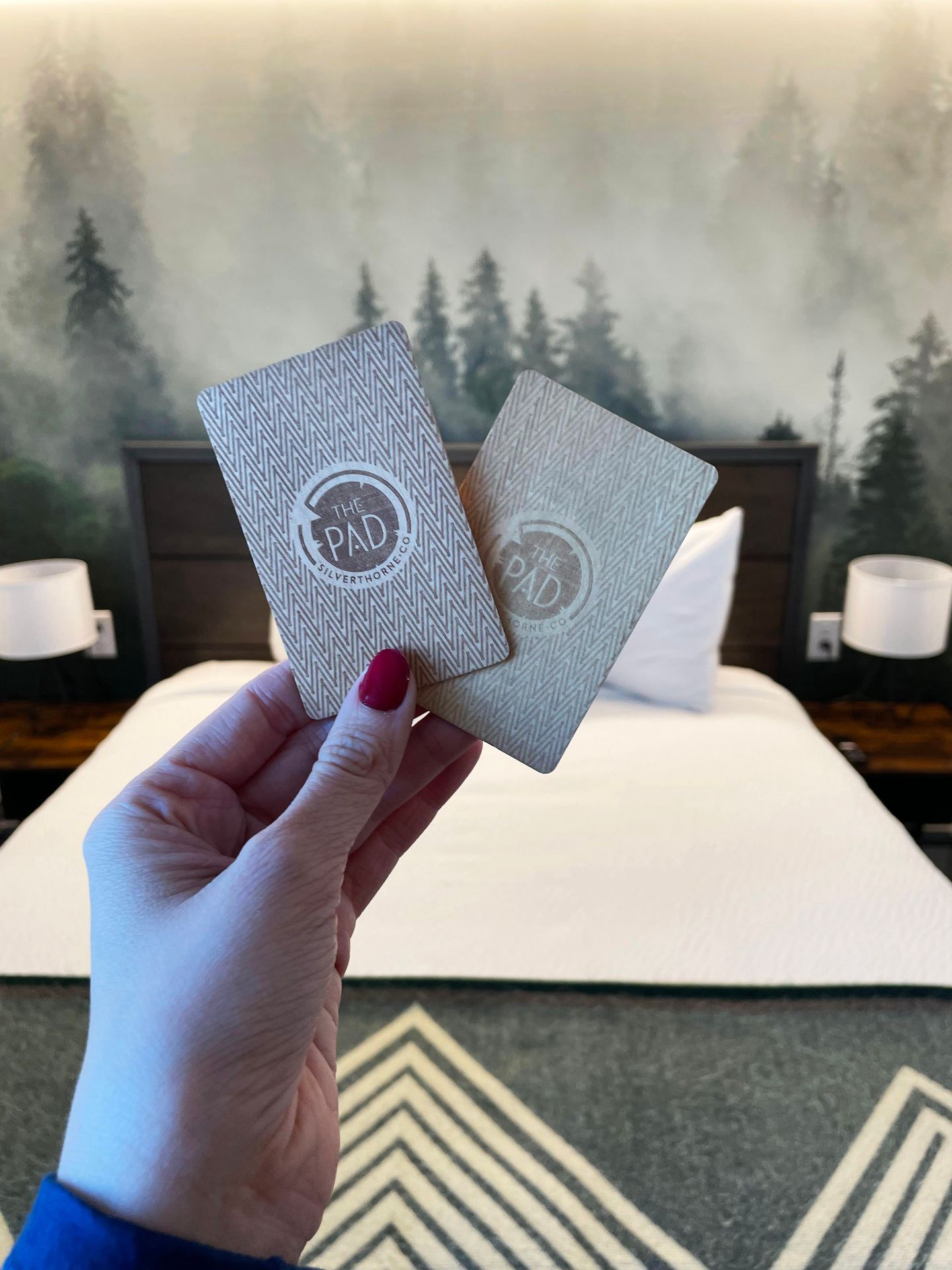 Holding The Pad room keys, which are embossed wood