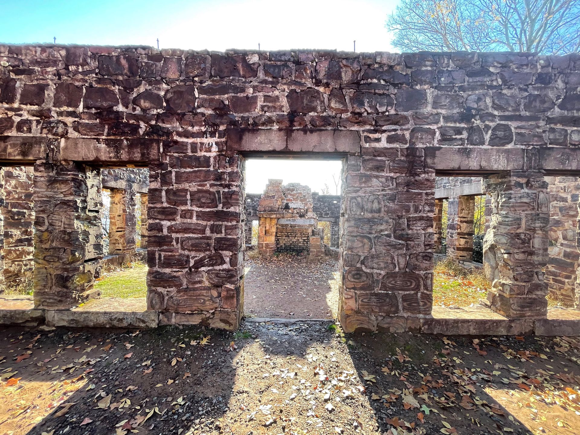 Brick ruins at The College Lodge. It looks as if the outer shell of the building is still in tact but there is no longer windows, a door or a roof.