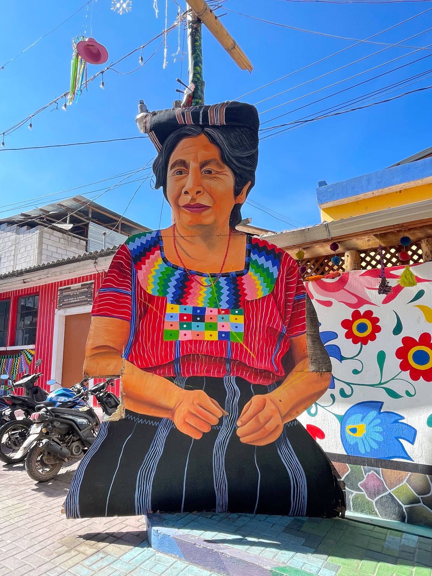 A large mural of a women wearing traditional Mayan clothing