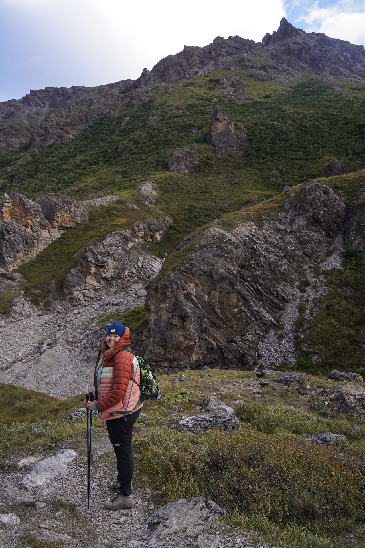 Lydia hiking with a view mountains behind her on the Savage River trail in Denali National Park